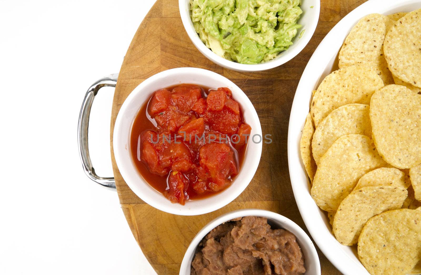 Food Appetizers Chips and Salsa Refried Beans Guacamole on Wood Cutting Board