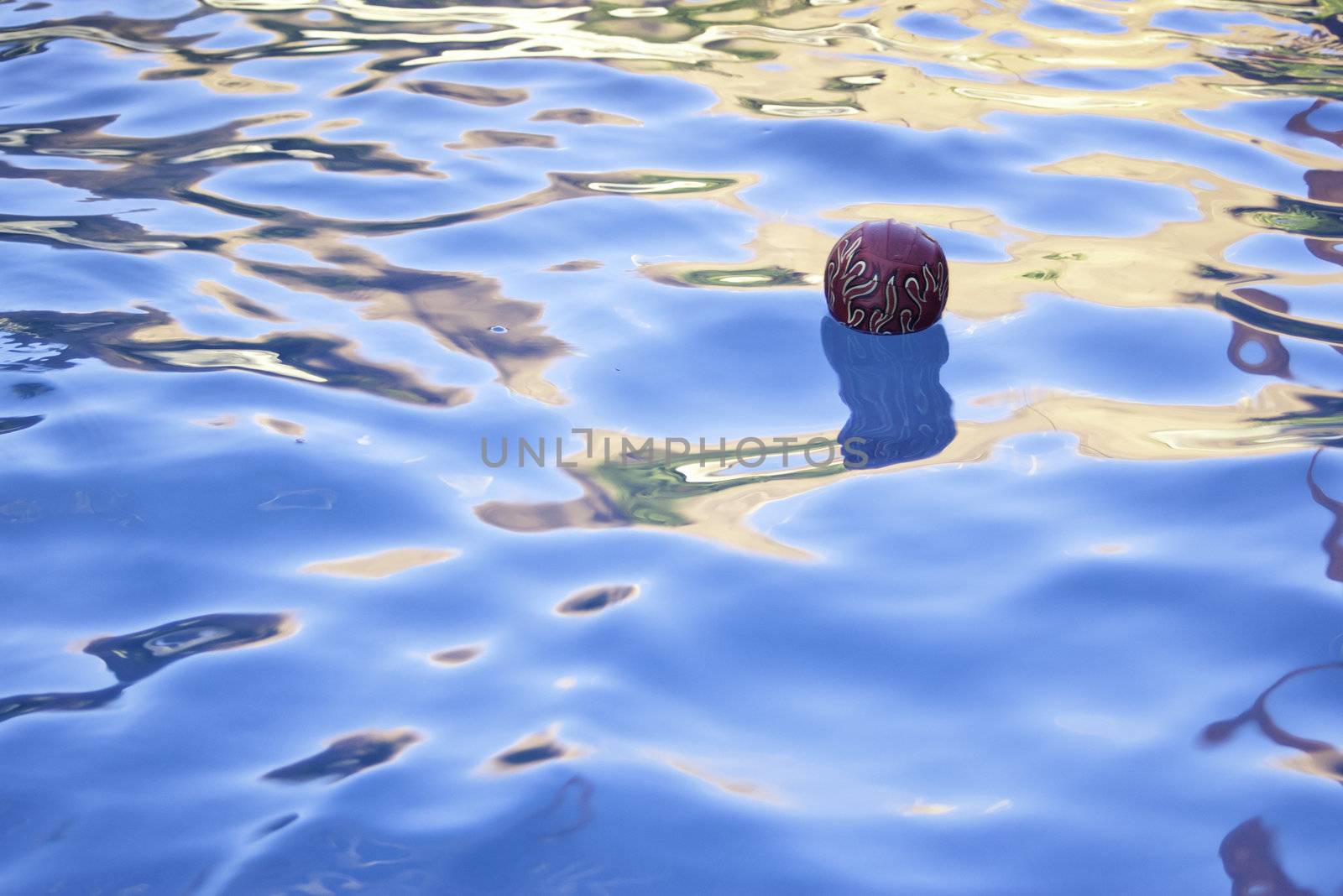 red flame ball floating in pool in summer time