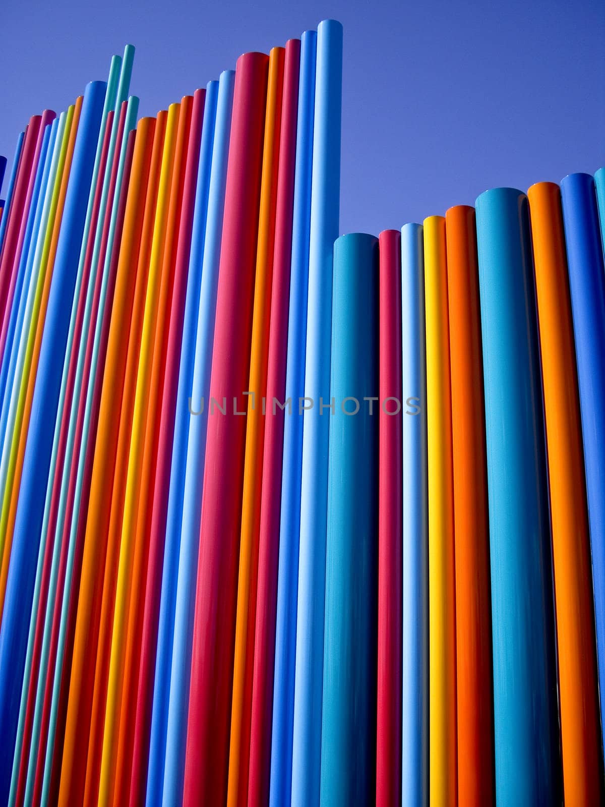 Shining poles of primary colors against the blue sky