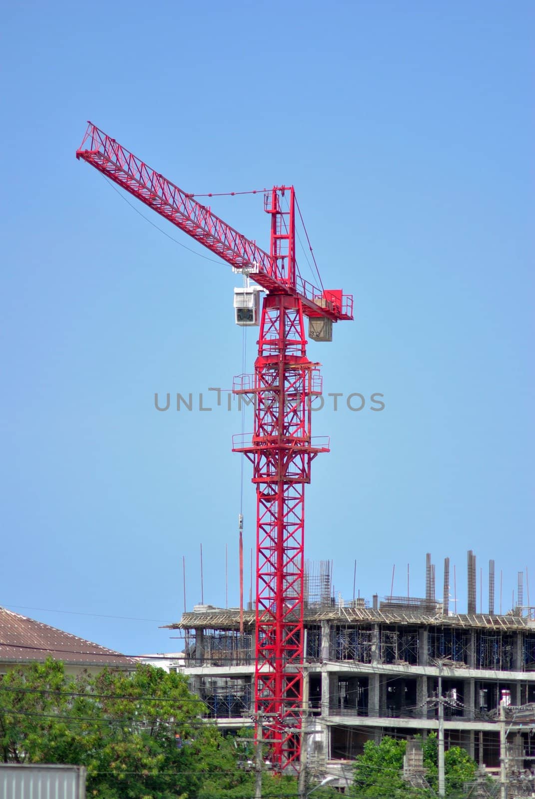 Red crane tower with construction site by pixbox77