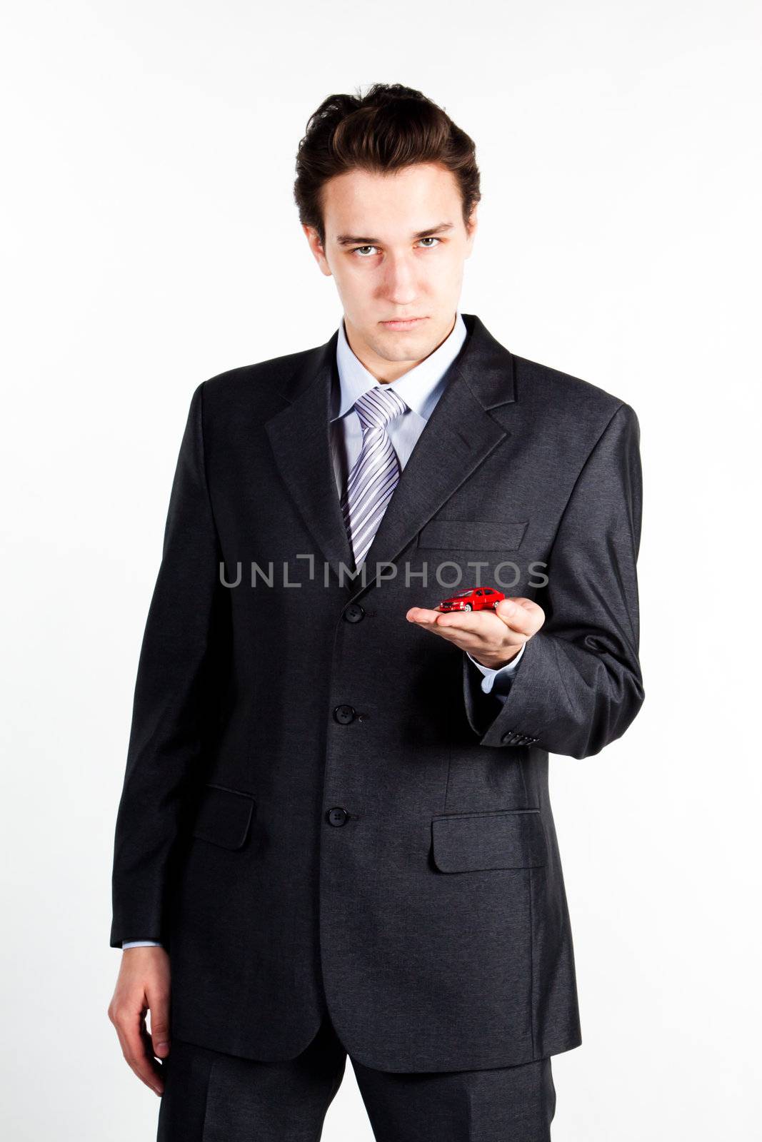 portrait of a young manager for motor with a small red toy car