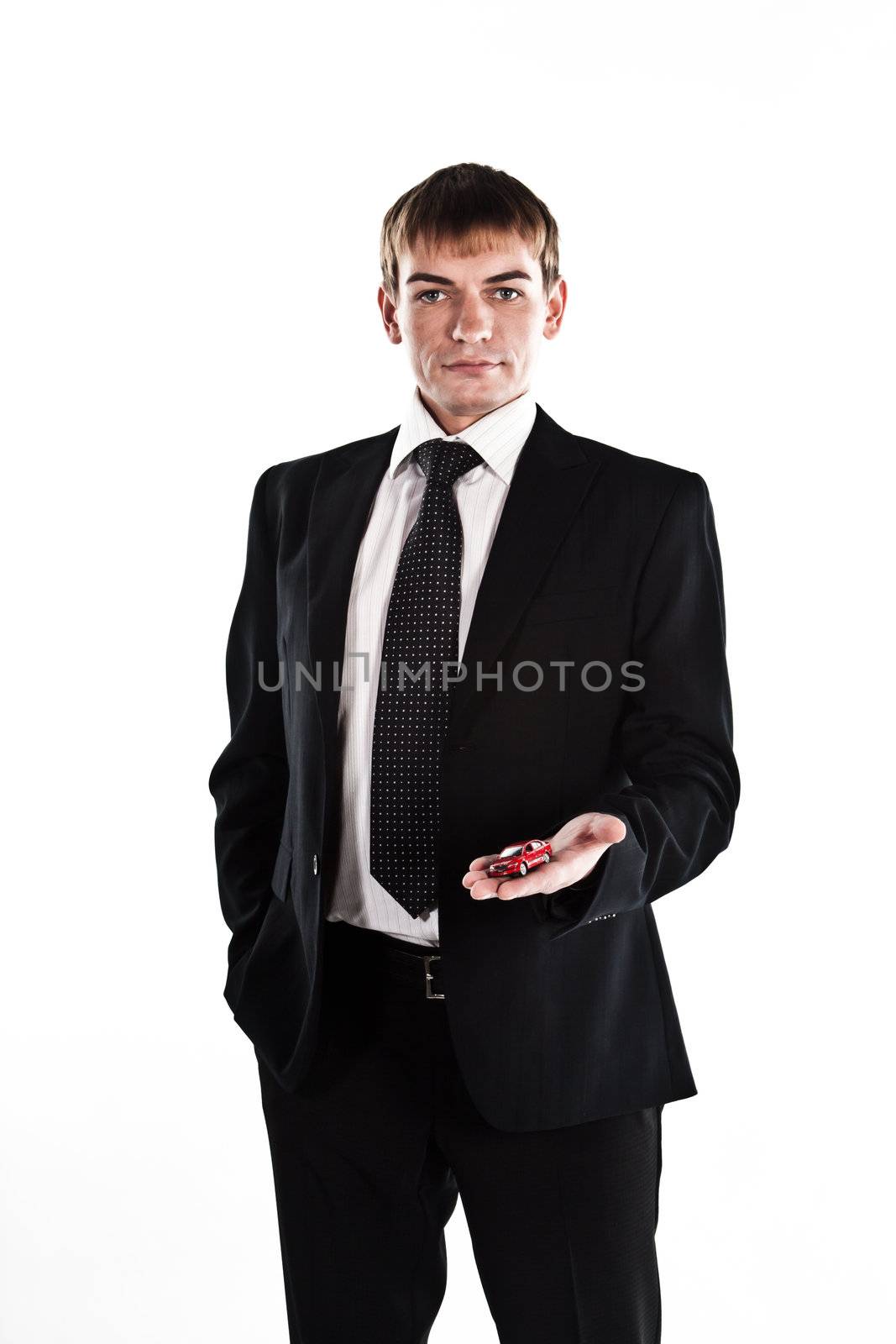 portrait of a young manager for motor with a small red toy car