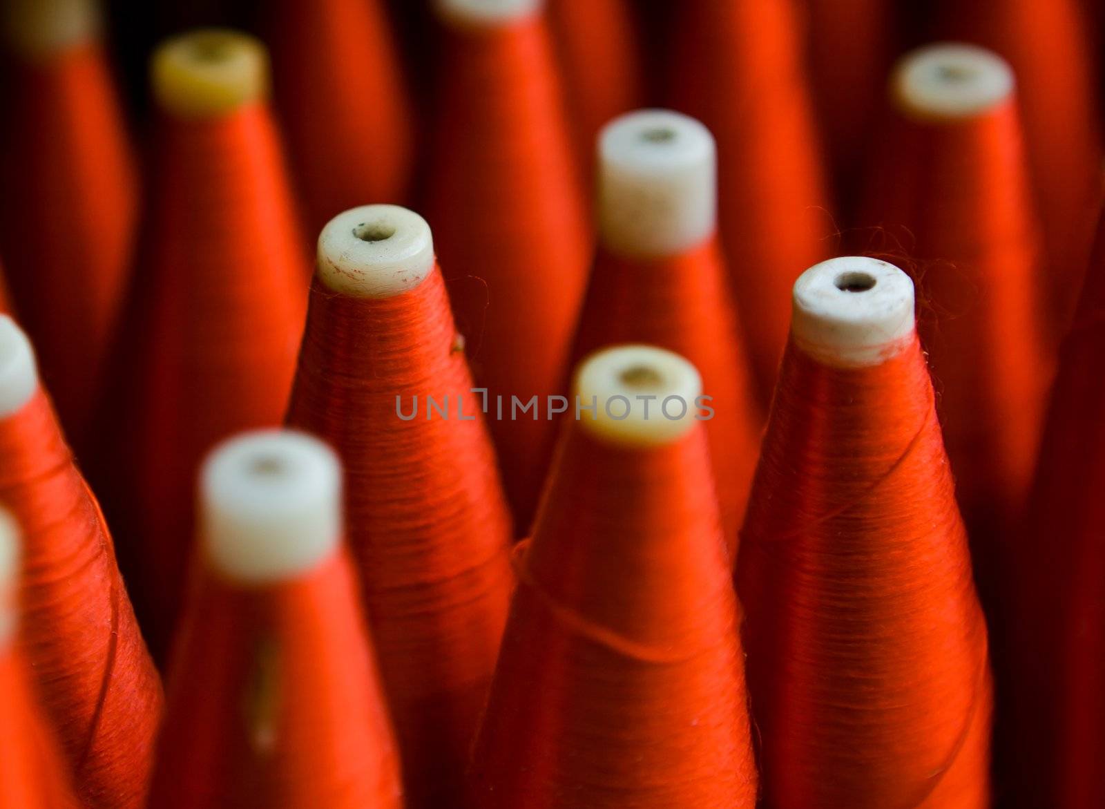 A background with the colorful of the cone threads from textile