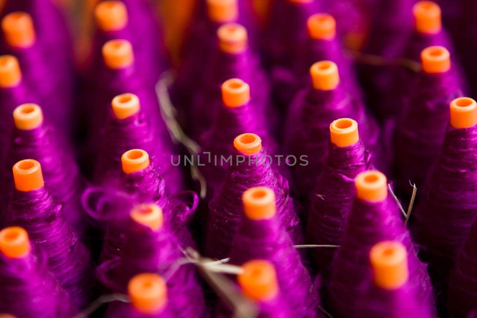 A background with the colorful of the cone threads from textile