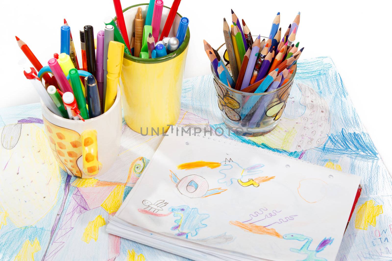 Abstract painting  and pen holders  with colored pens on a white background 