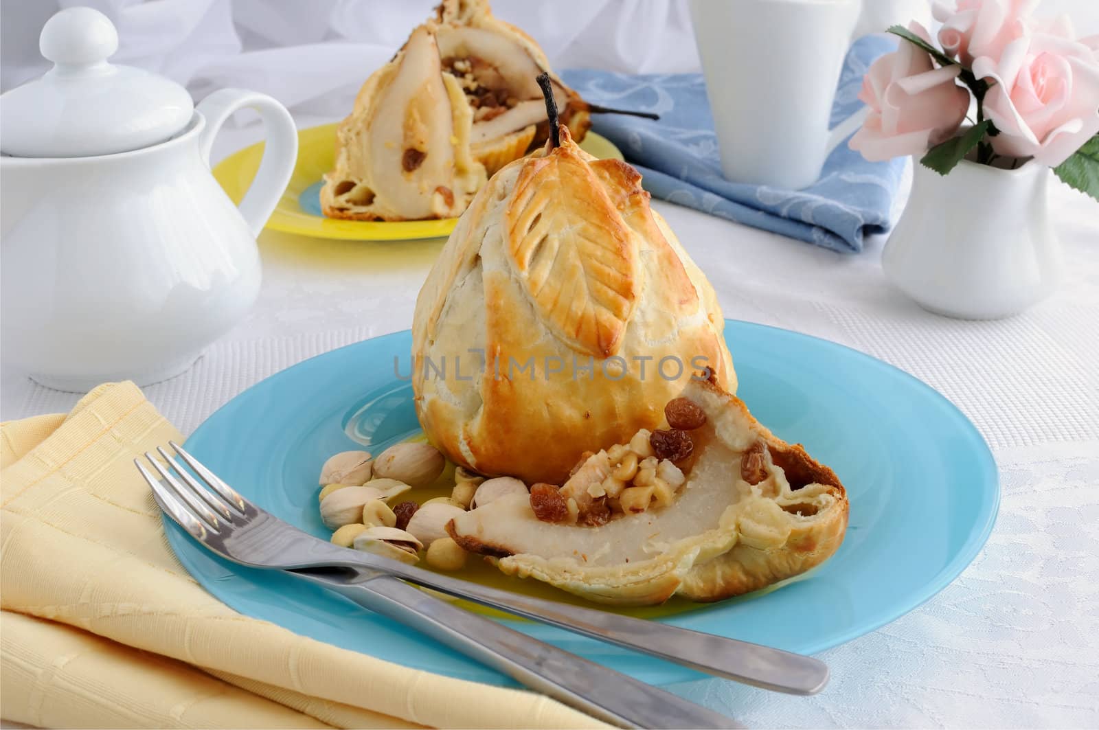 Baked pears stuffed with a mixture of nuts and raisins in the dough