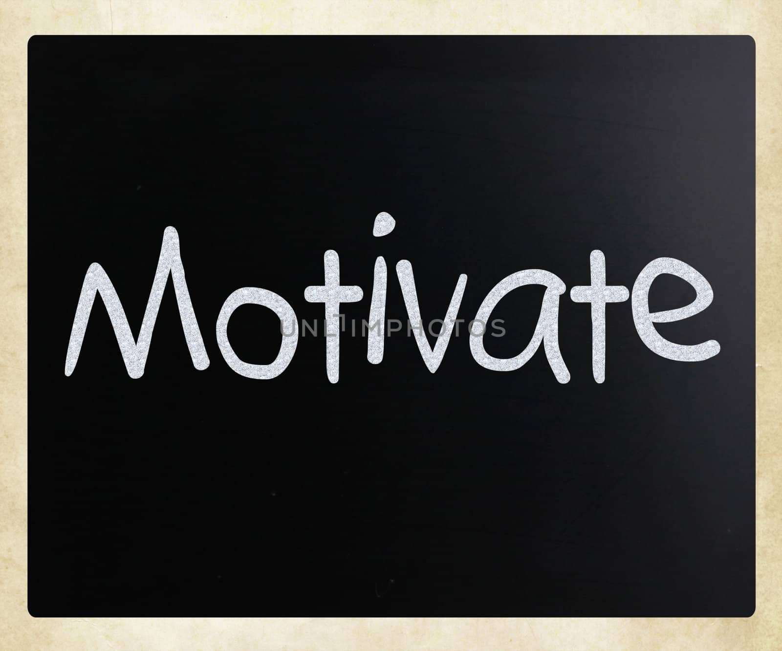 "Motivate" handwritten with white chalk on a blackboard