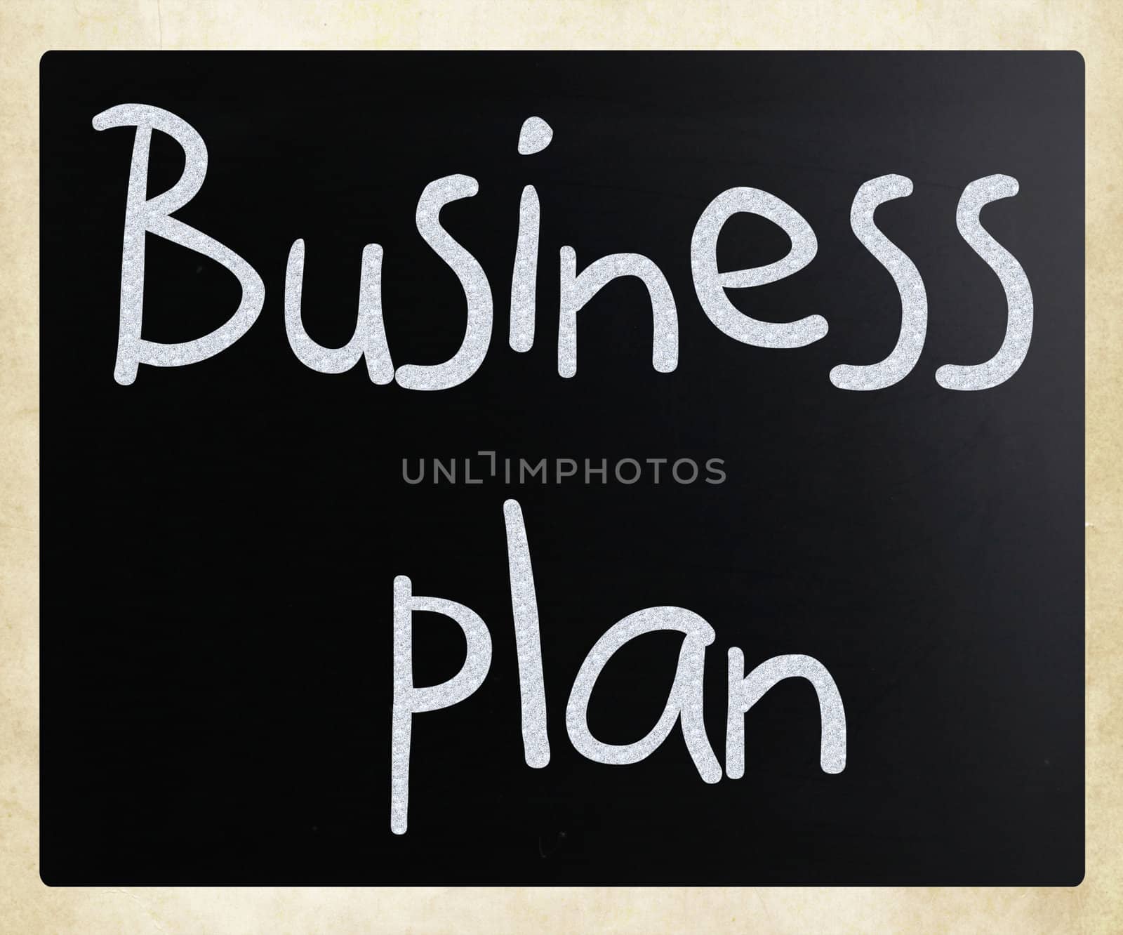 "Business plan" handwritten with white chalk on a blackboard