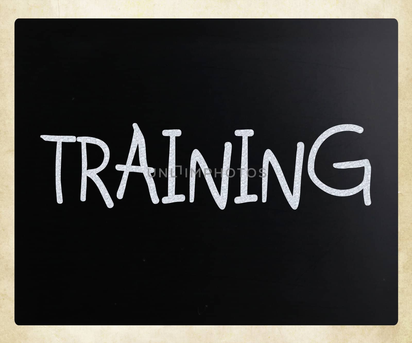 "Training" handwritten with white chalk on a blackboard