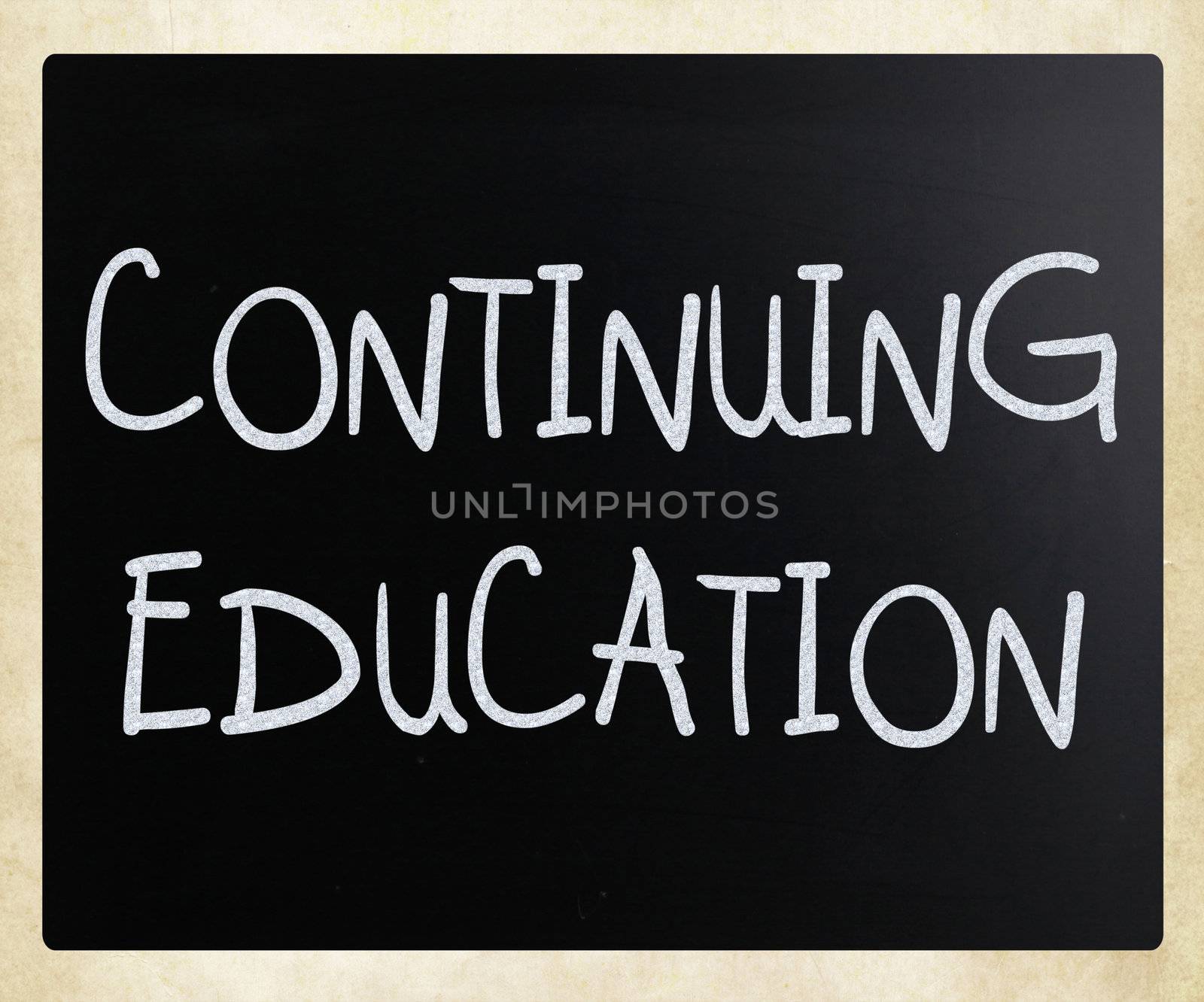 "Continuing Education" handwritten with white chalk on a blackboard