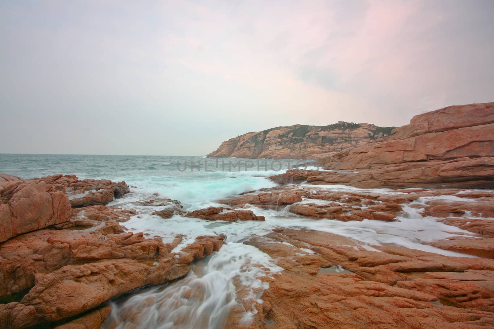 rocky sea coast and blurred water in shek o,hong kong 
