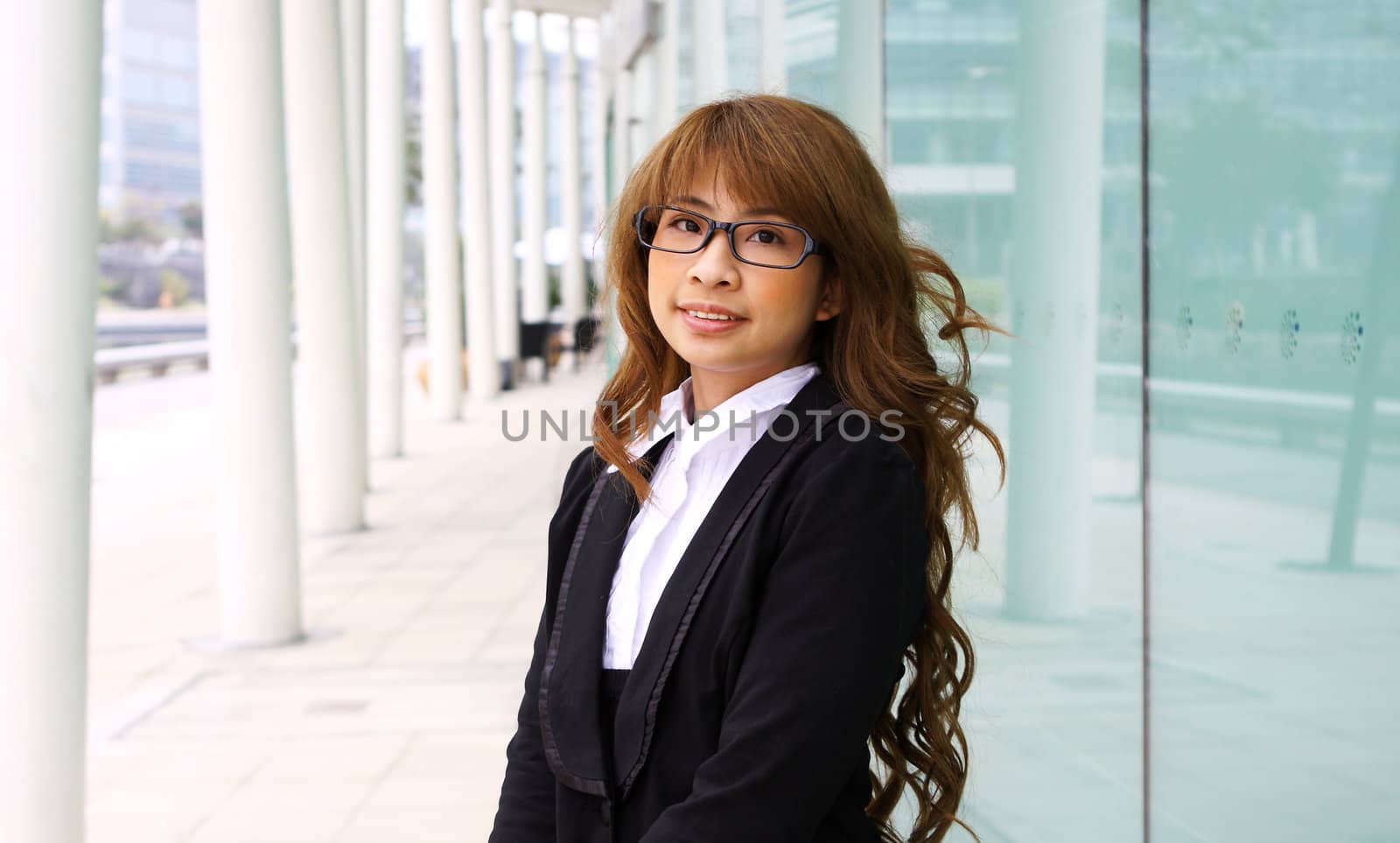 portrait of a young business woman in an office  by cozyta