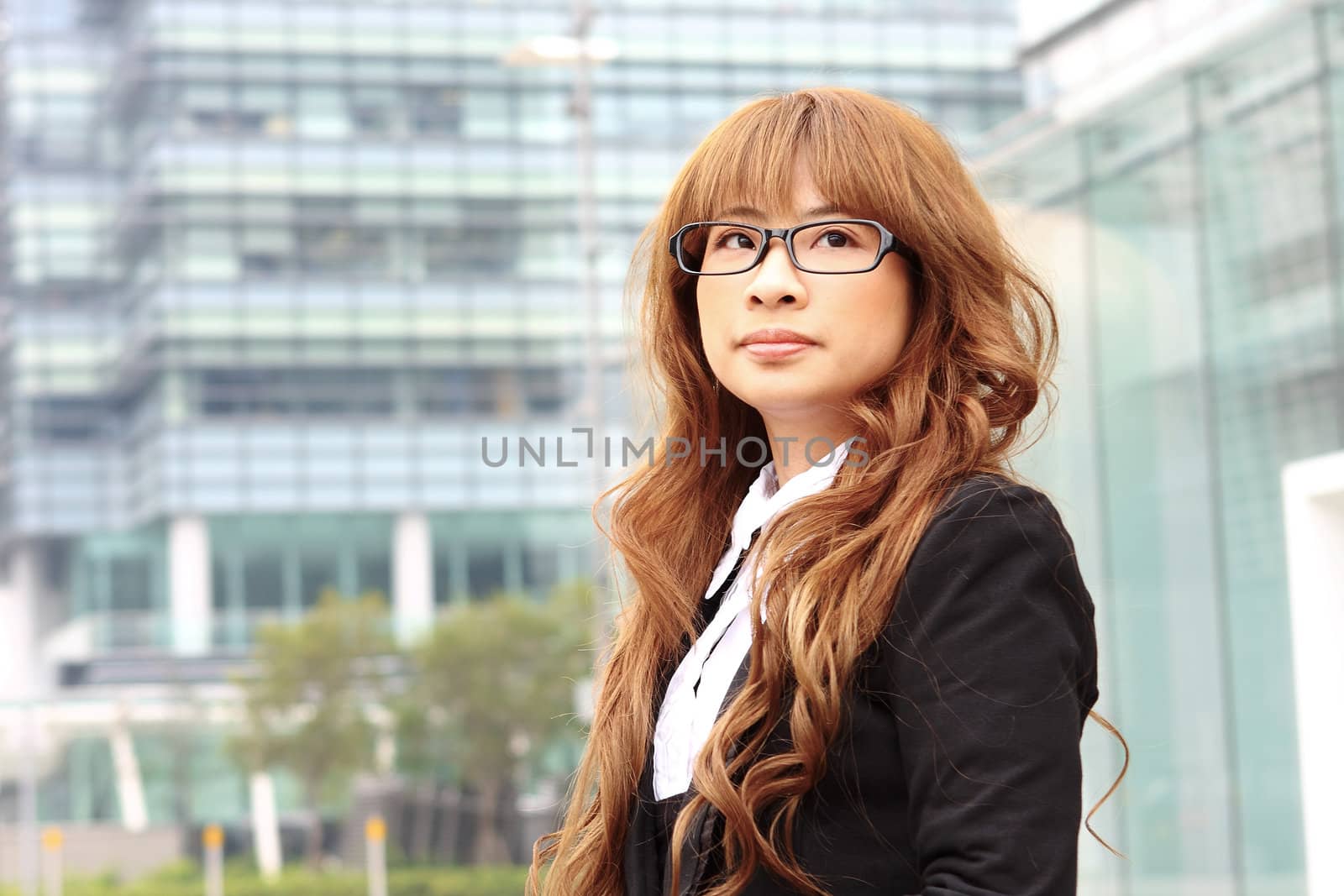 young business woman and an office background