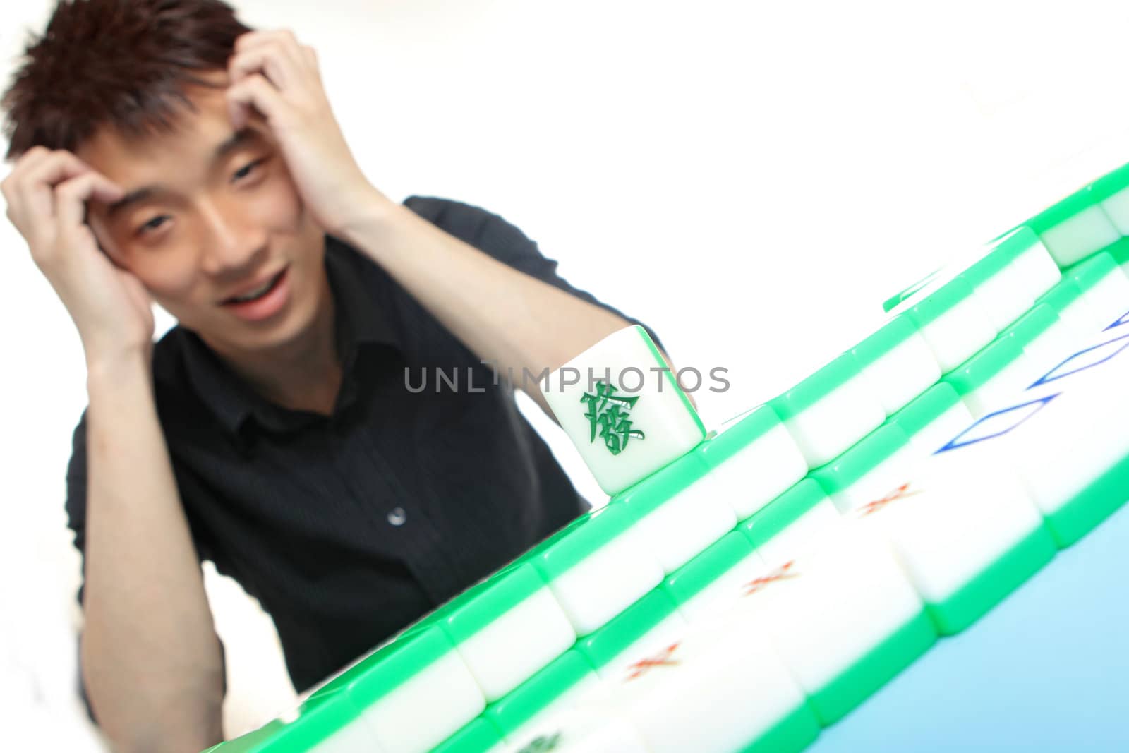 Chinese man play Mahjong, traditional China gamble. 