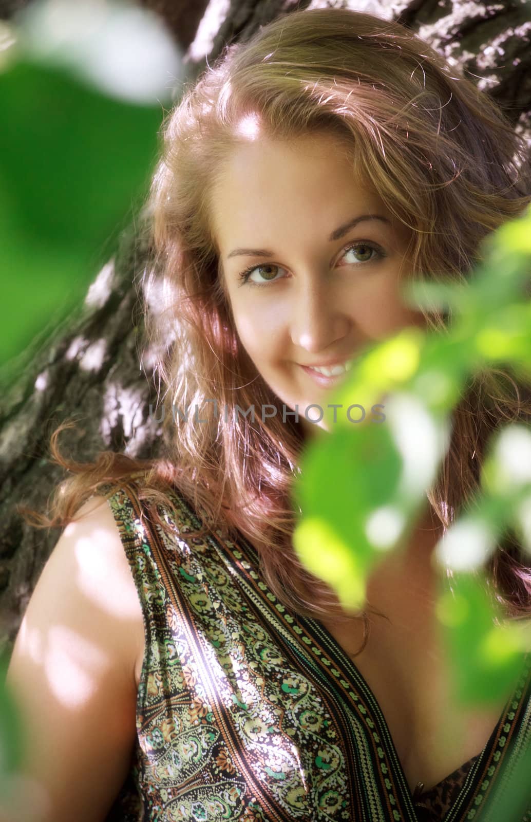 beautiful girl standing in shadow of leaves