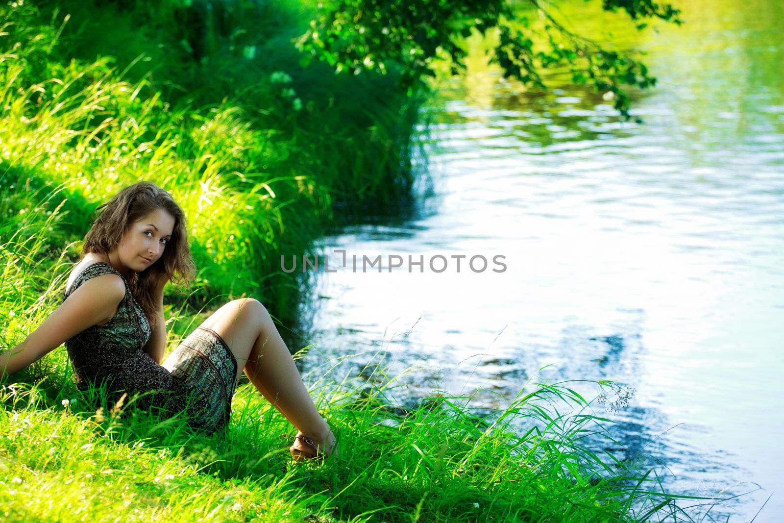 beautyful woman sitting on shore