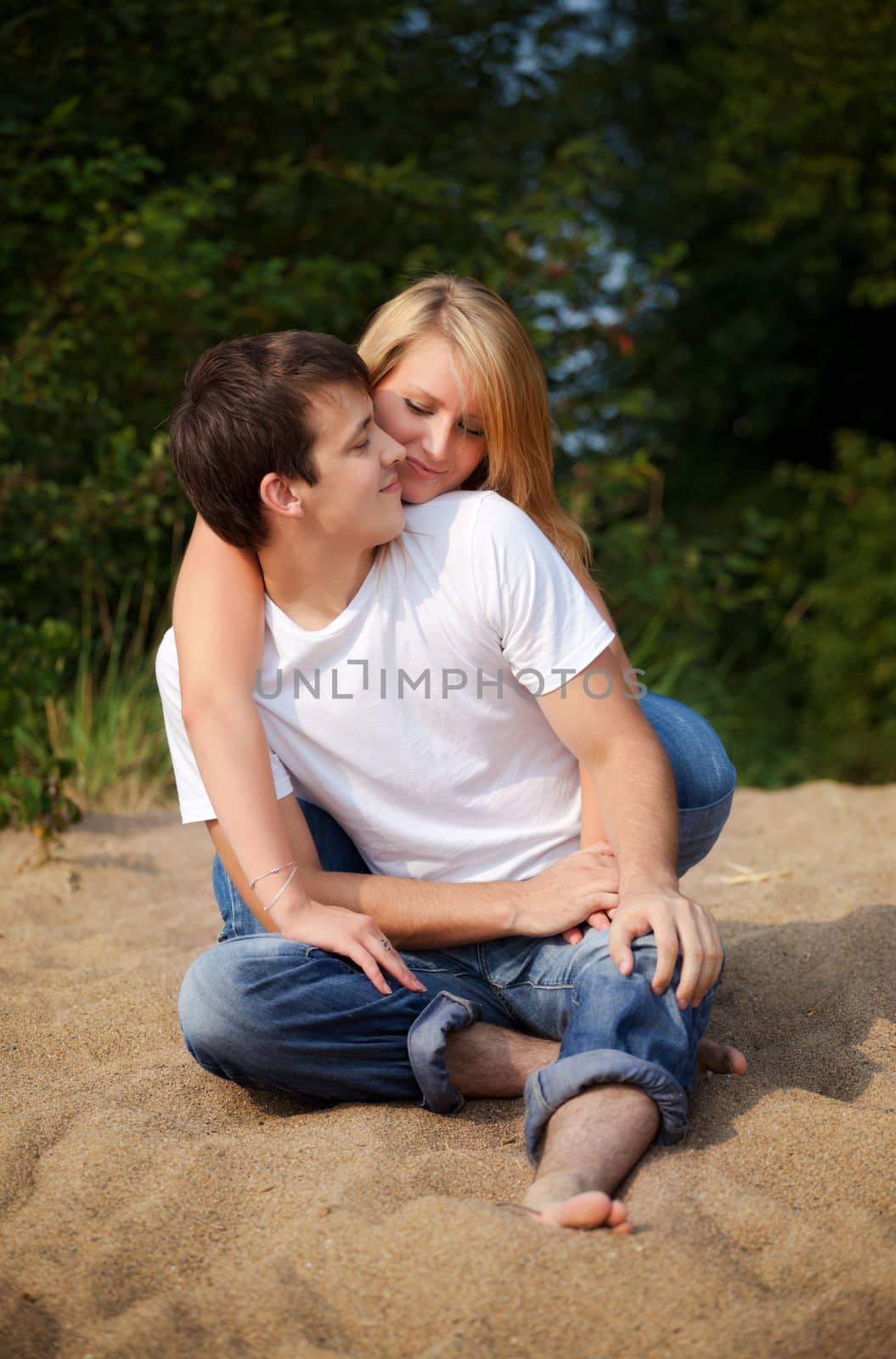couple sitting on a sand by petr_malyshev