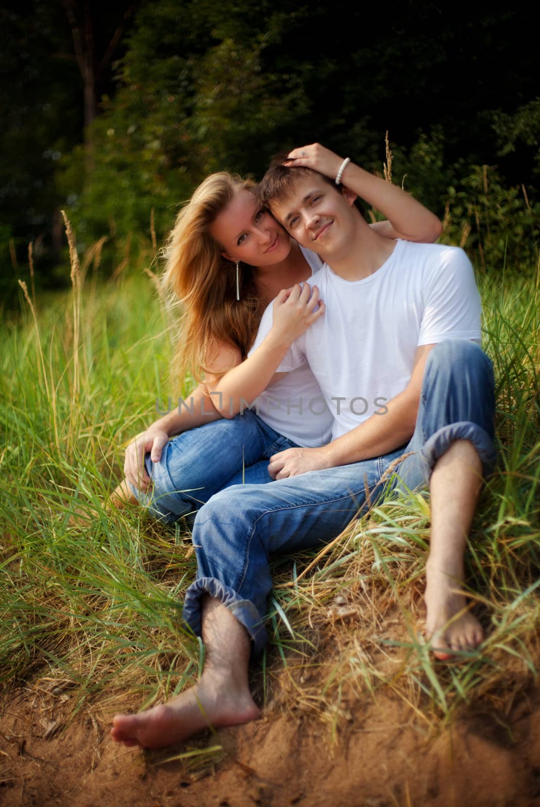 young couple embrace in high grass