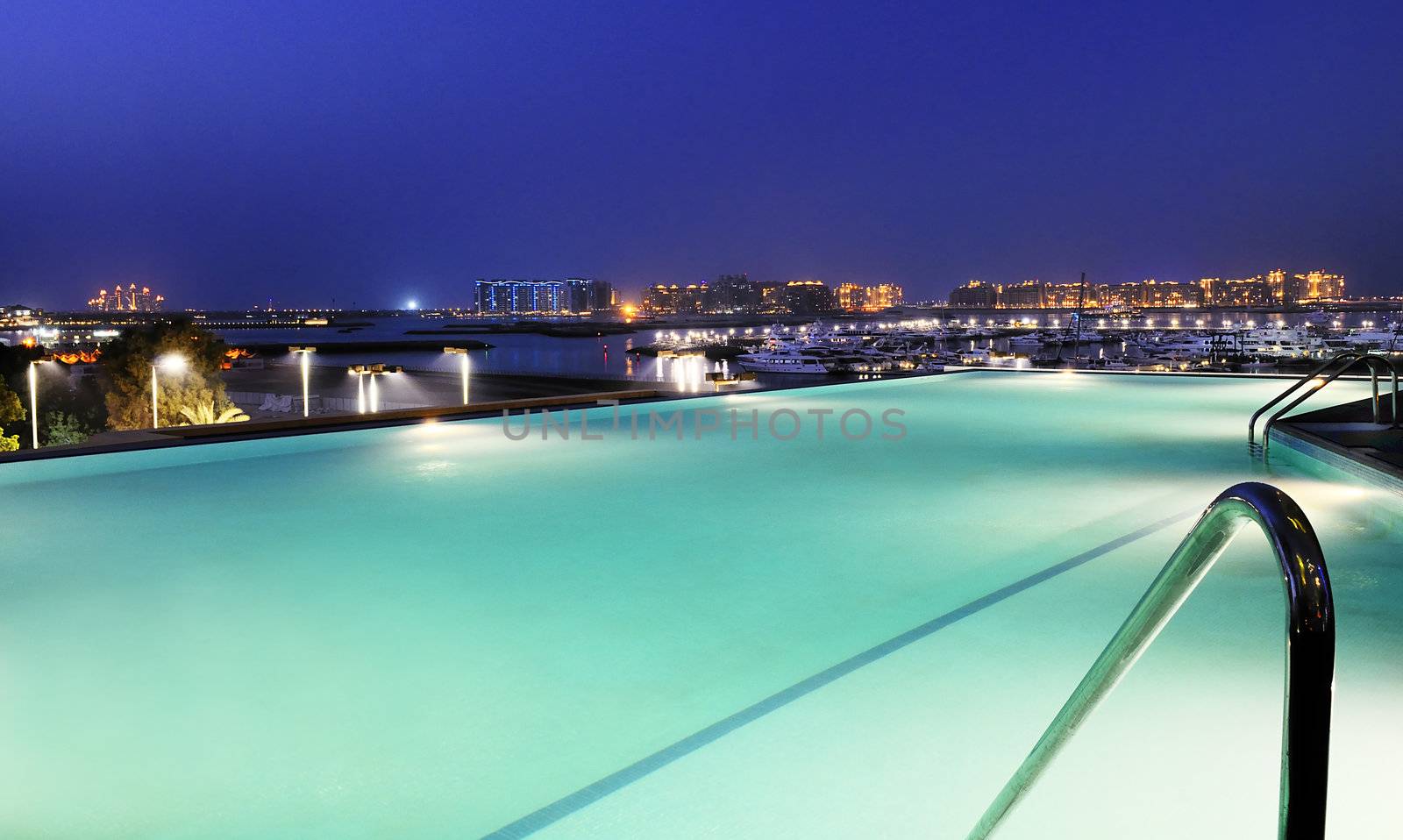 view of dubai by night by the pool 