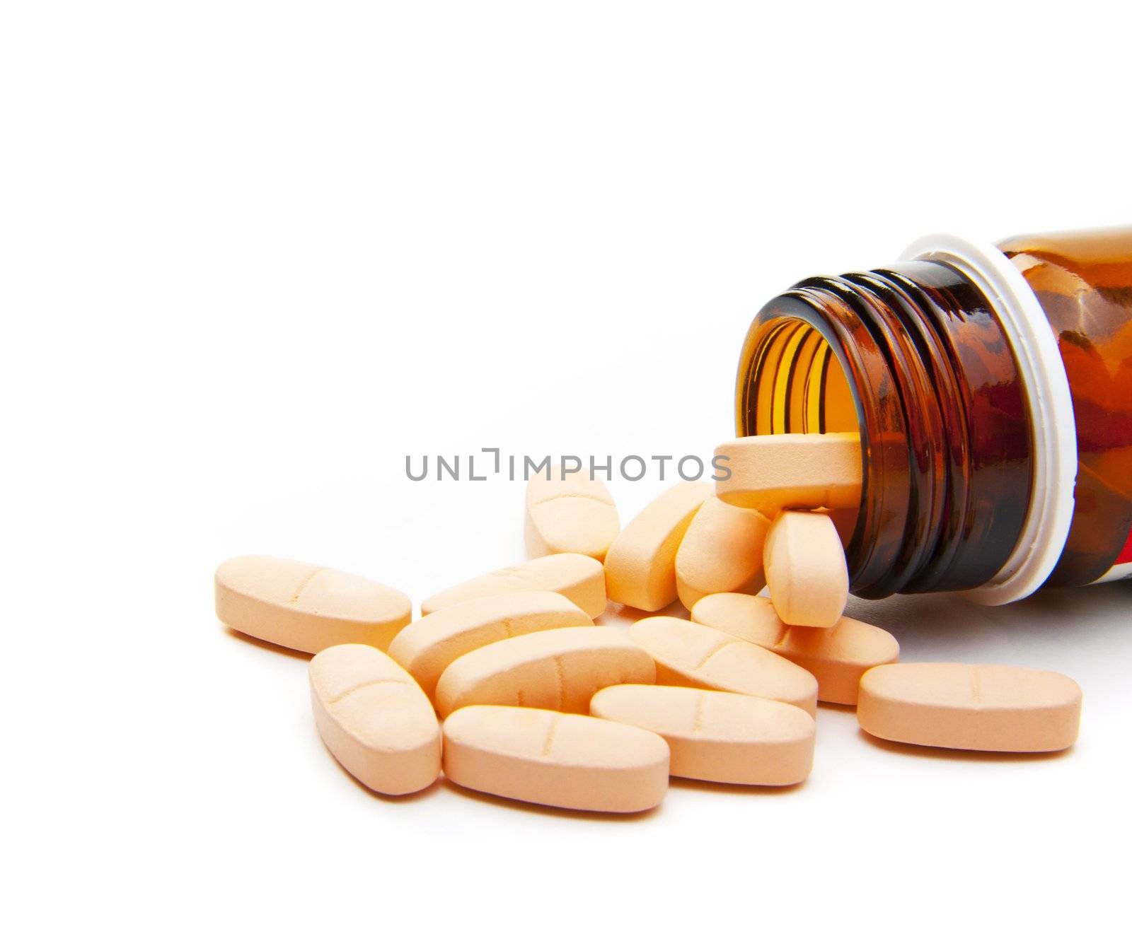 Pills from bottle on the white background