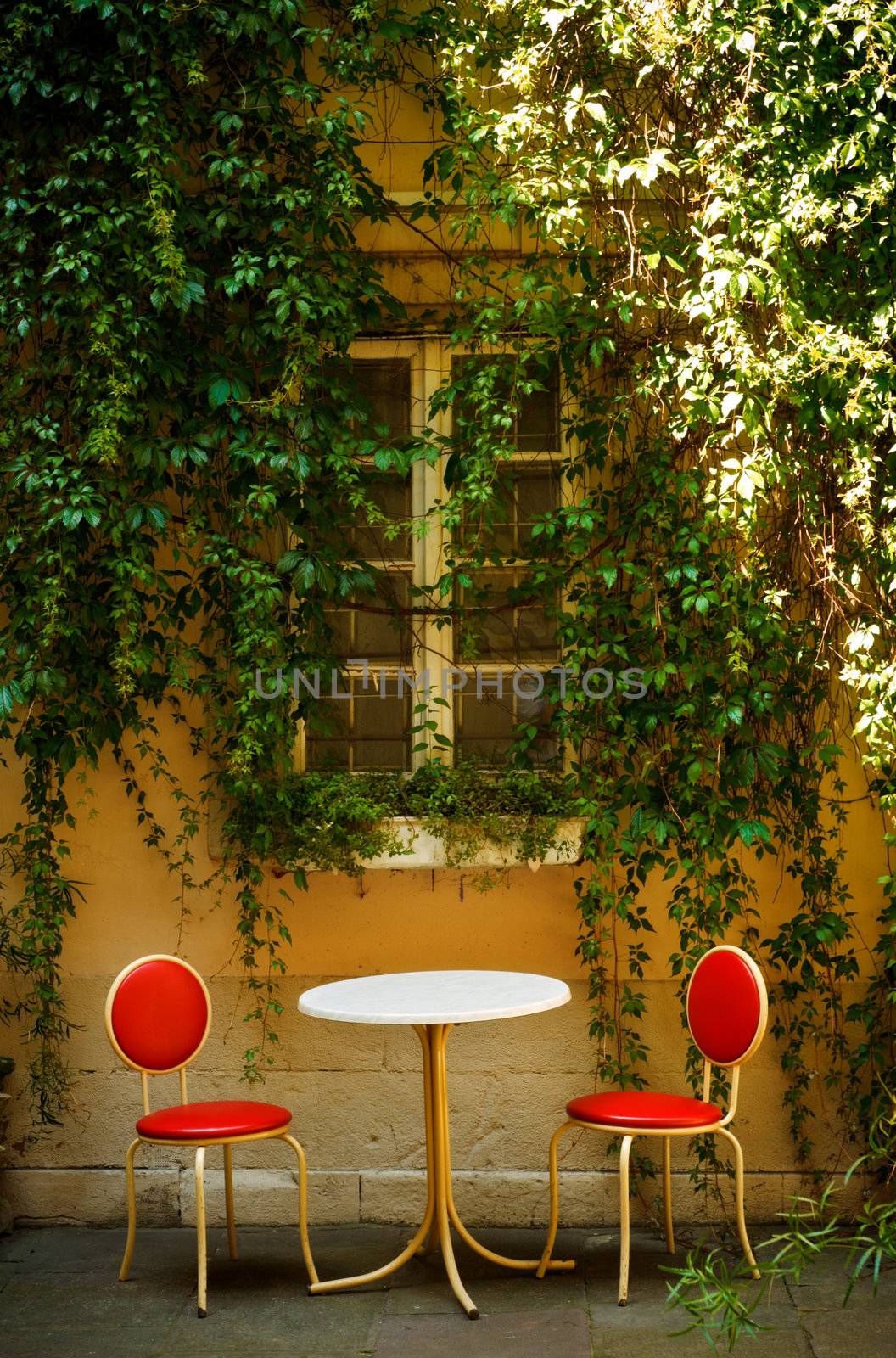 outdoor cafe with table and two chairs