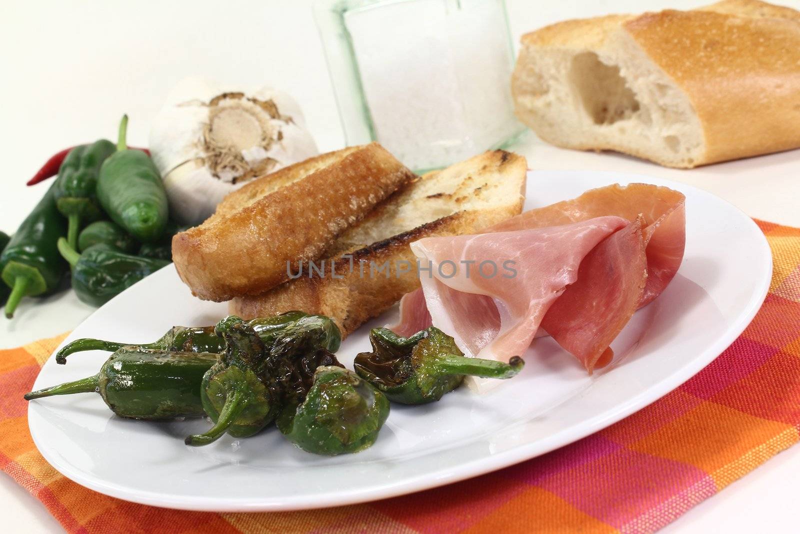 a plate of fried pimientos and Serrano ham 