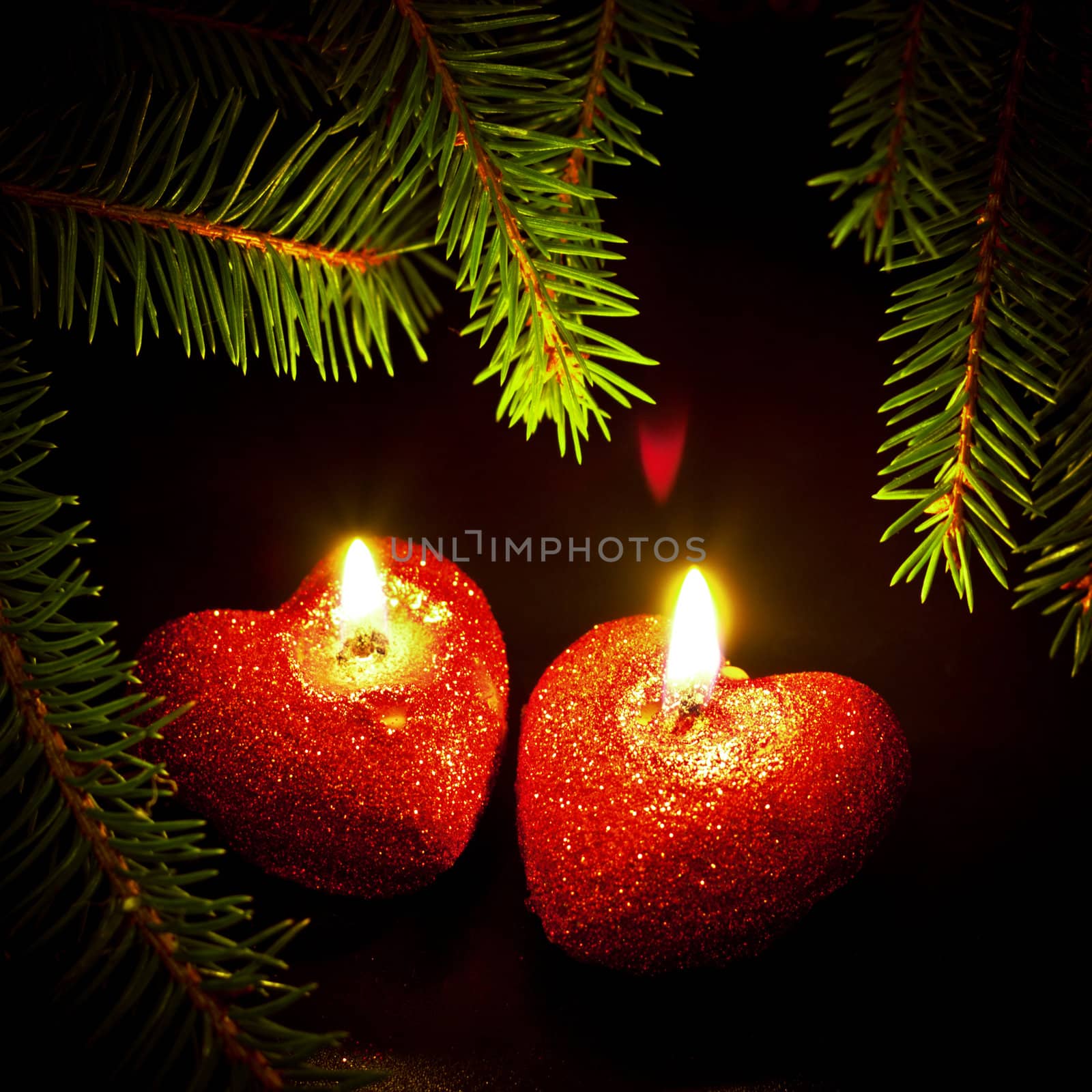 christmas card with two heart-shaped candles