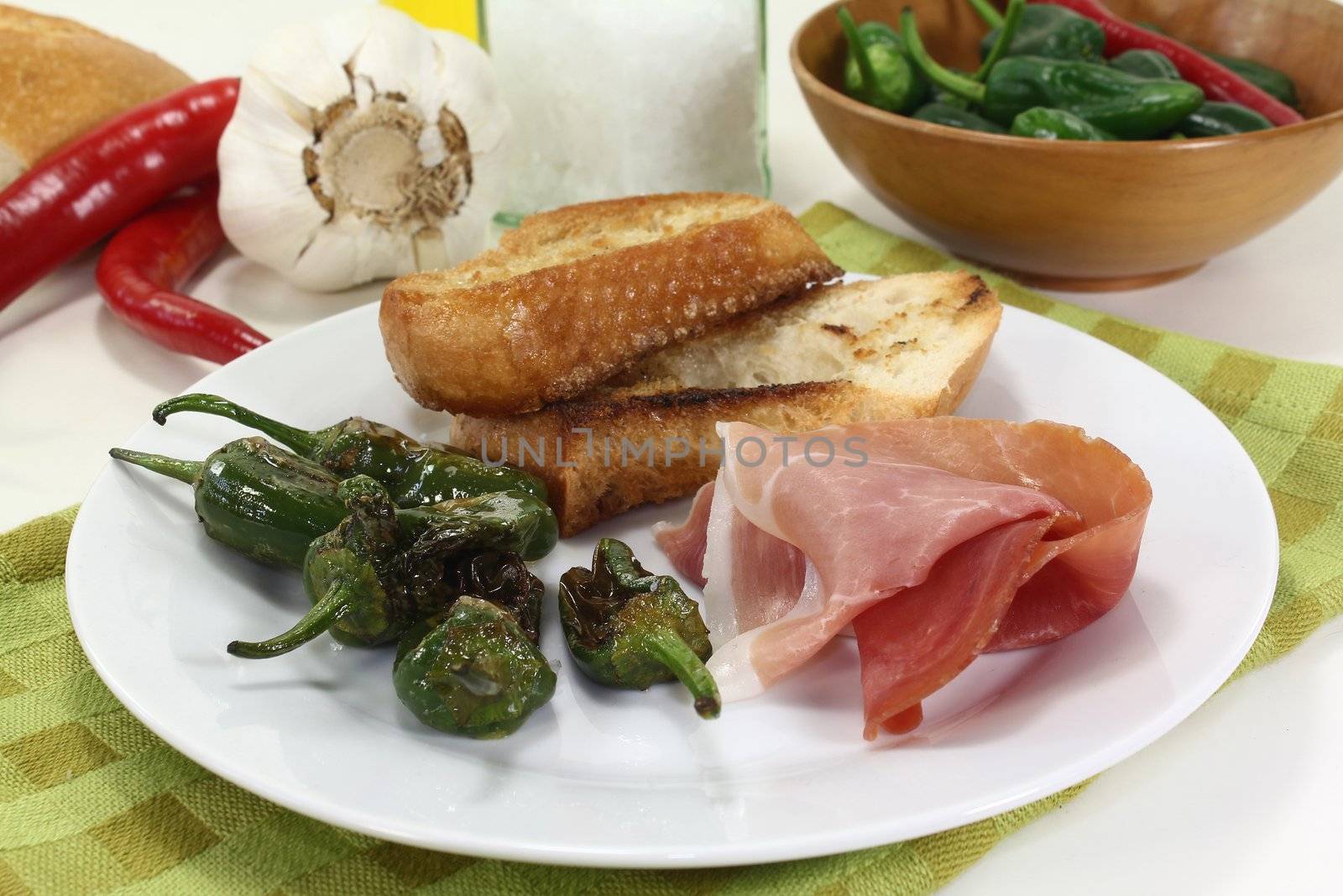 a plate of fried pimientos and Serrano ham