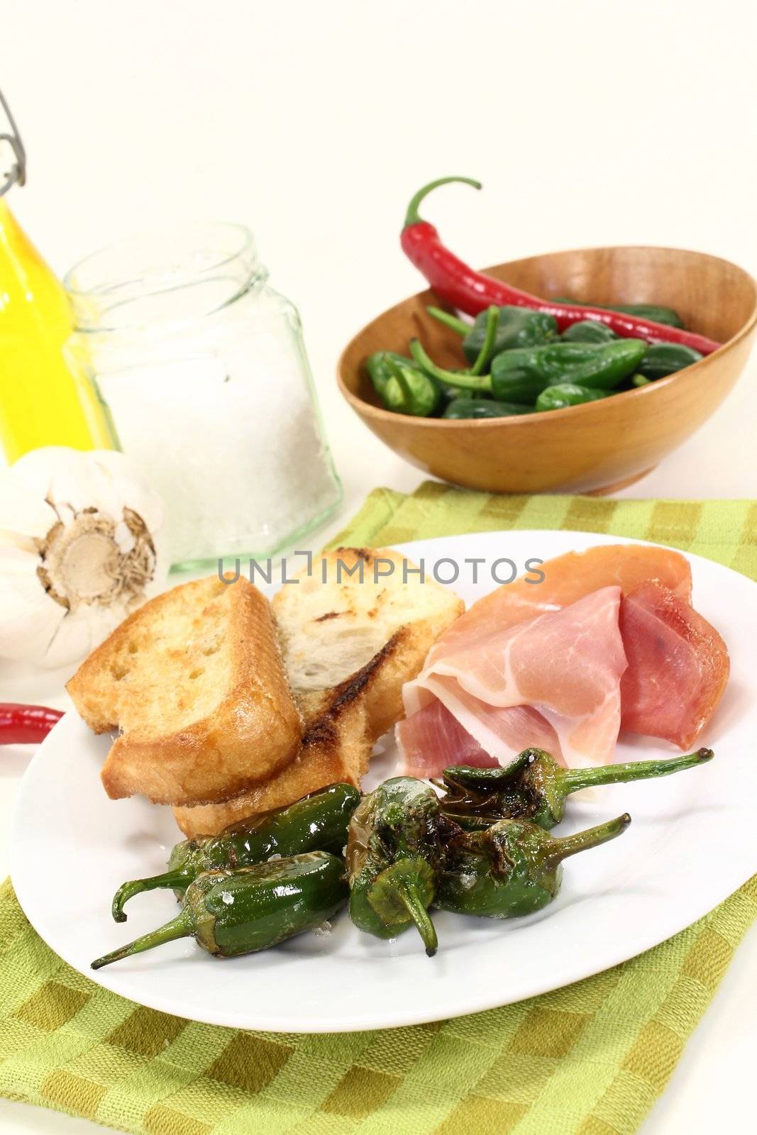 a plate of fried pimientos and Serrano ham