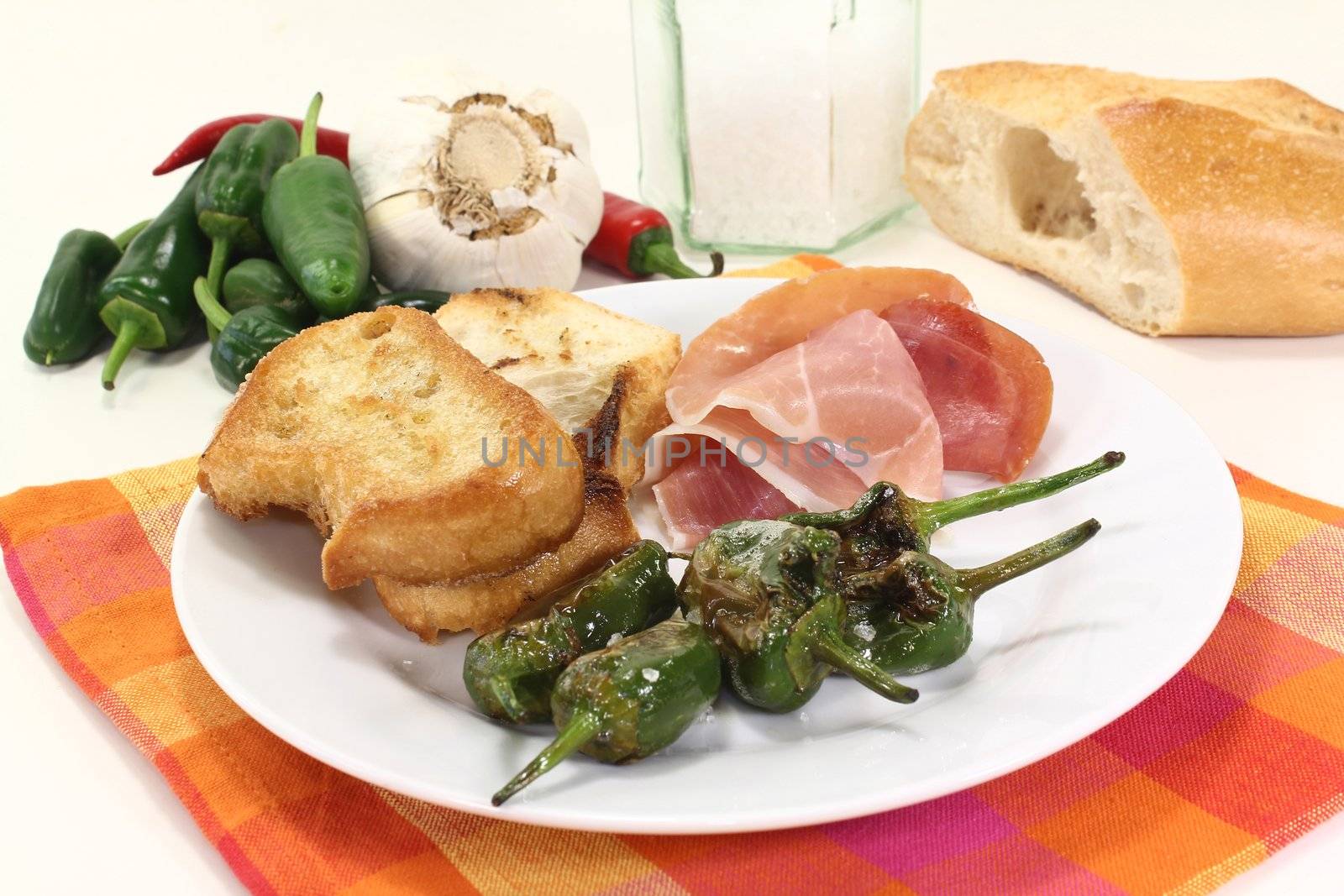 a plate of fried pimientos and Serrano ham