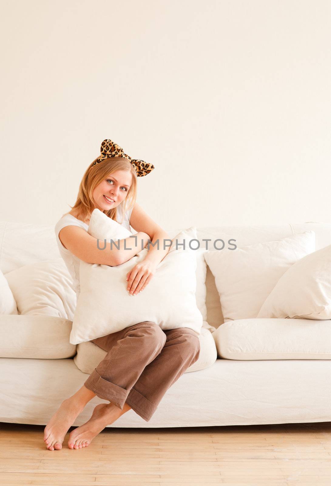 cute young woman with neko ears sitting on couch