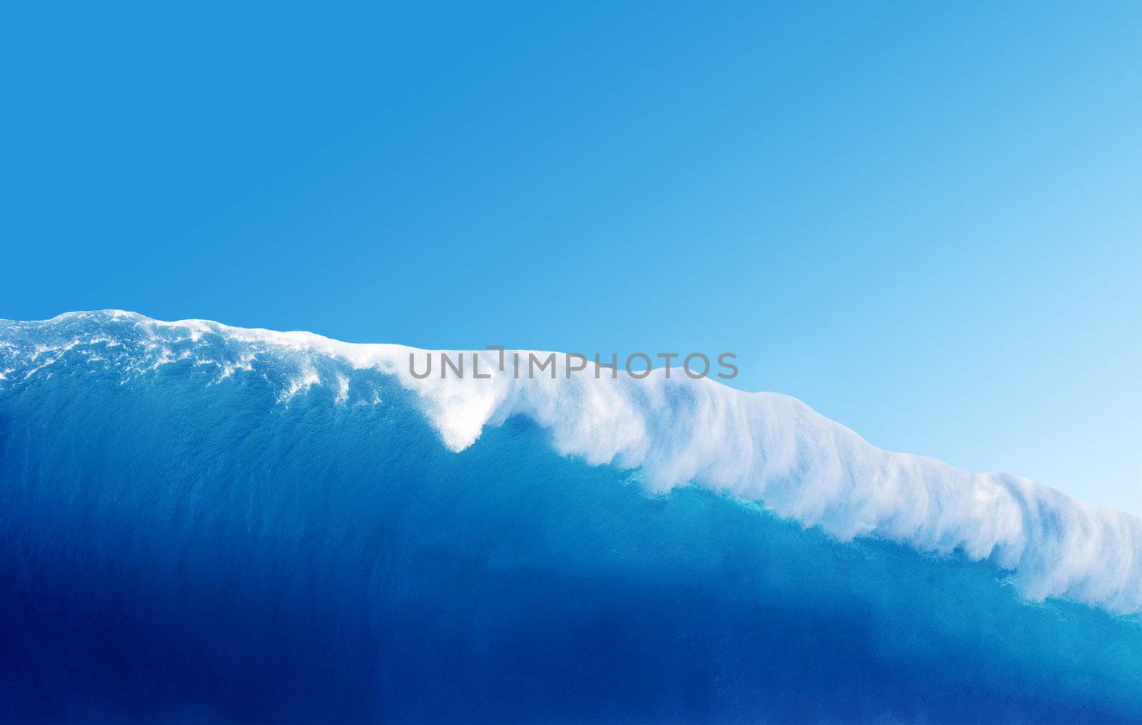 Large Blue Surfing Wave Breaks in the Ocean