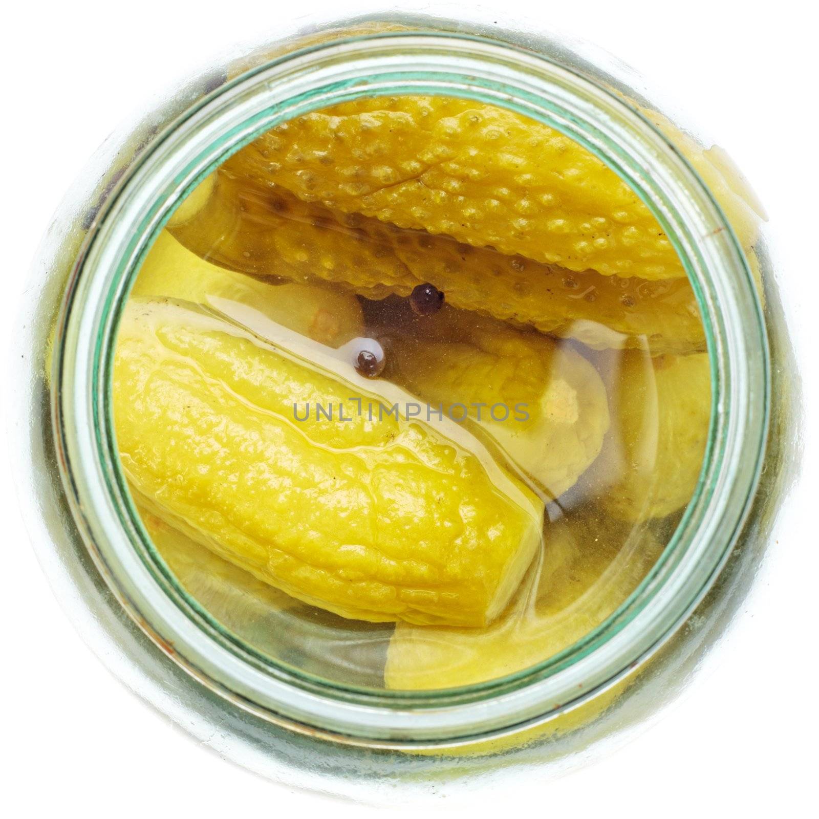 opened glass jar of green pickled cucumbers
