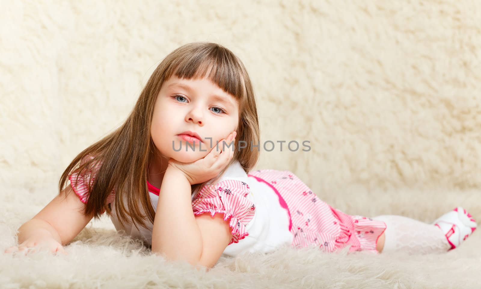 cute little girl laying on fur and dreaming