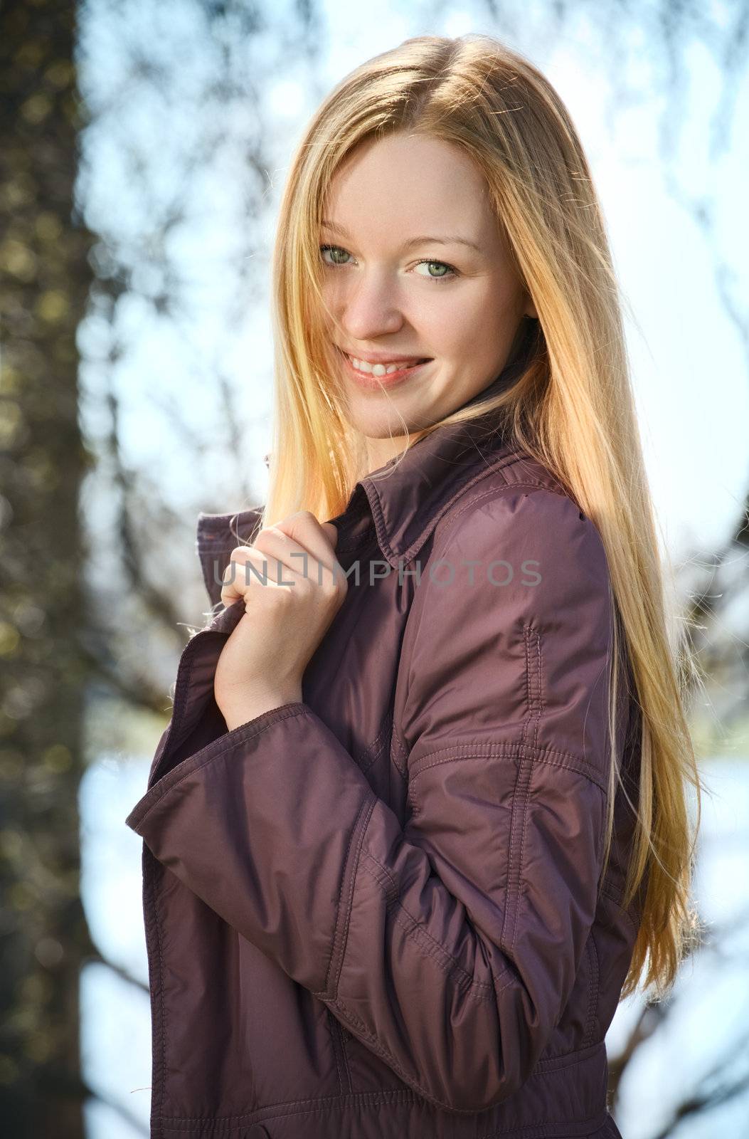beautiful smiling blond woman in spring park