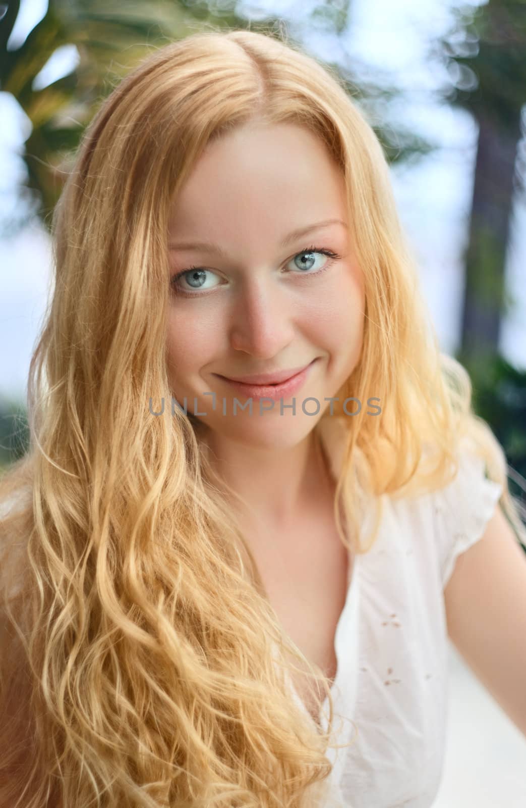 beautiful smiling girl with long curly blond hair