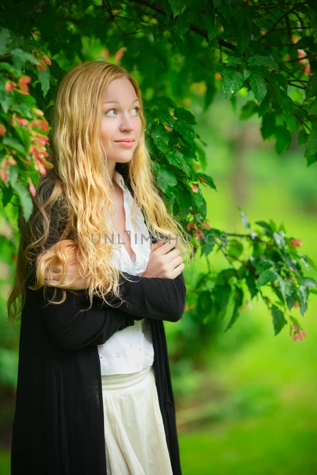 girl hiding from the rain under branch of tree