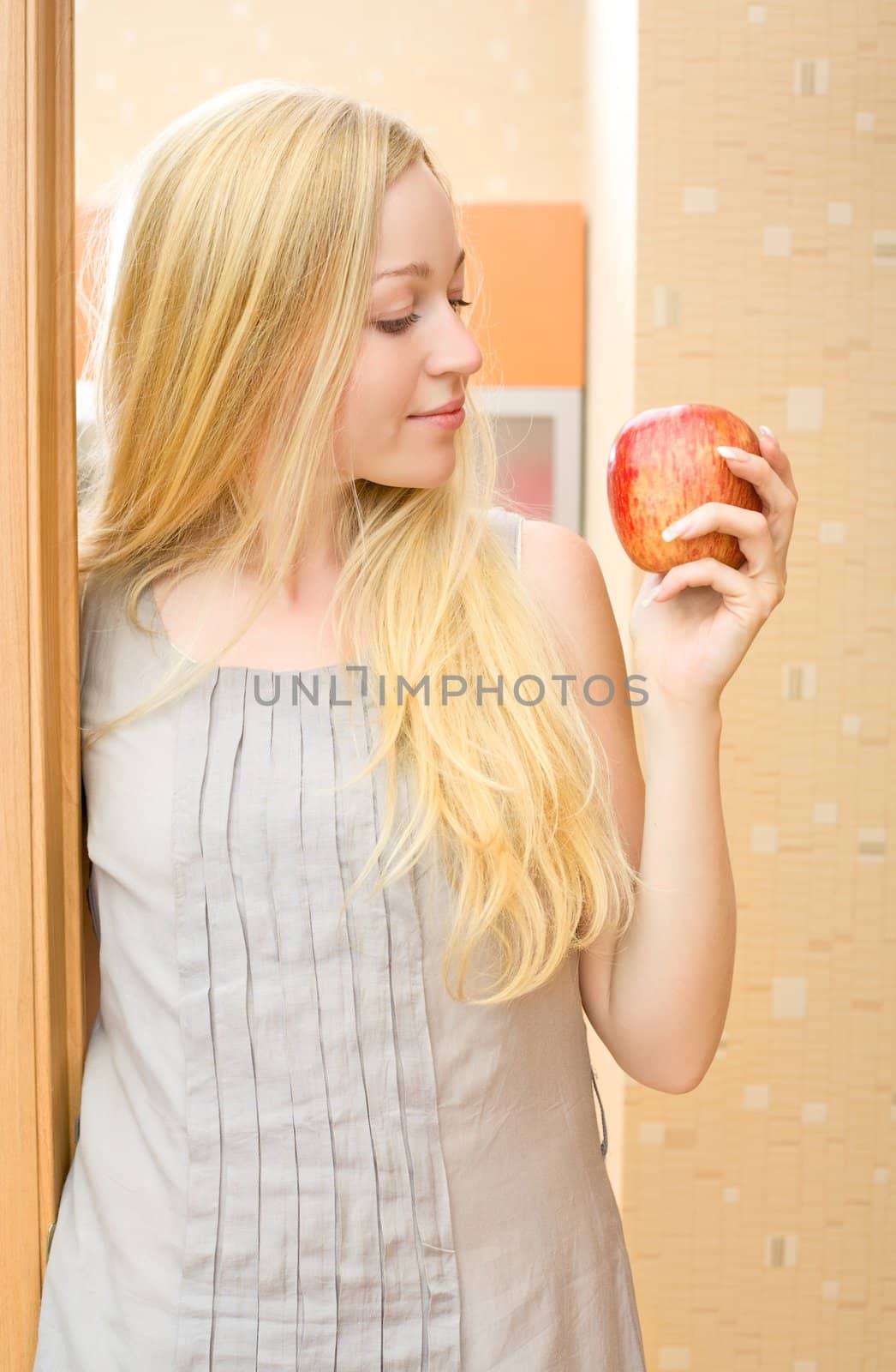 beautiful girl with fresh apple at home