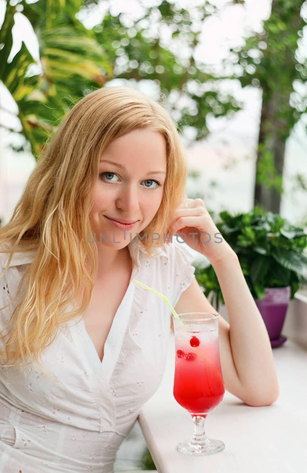beautiful girl with cocktail glass in cafe