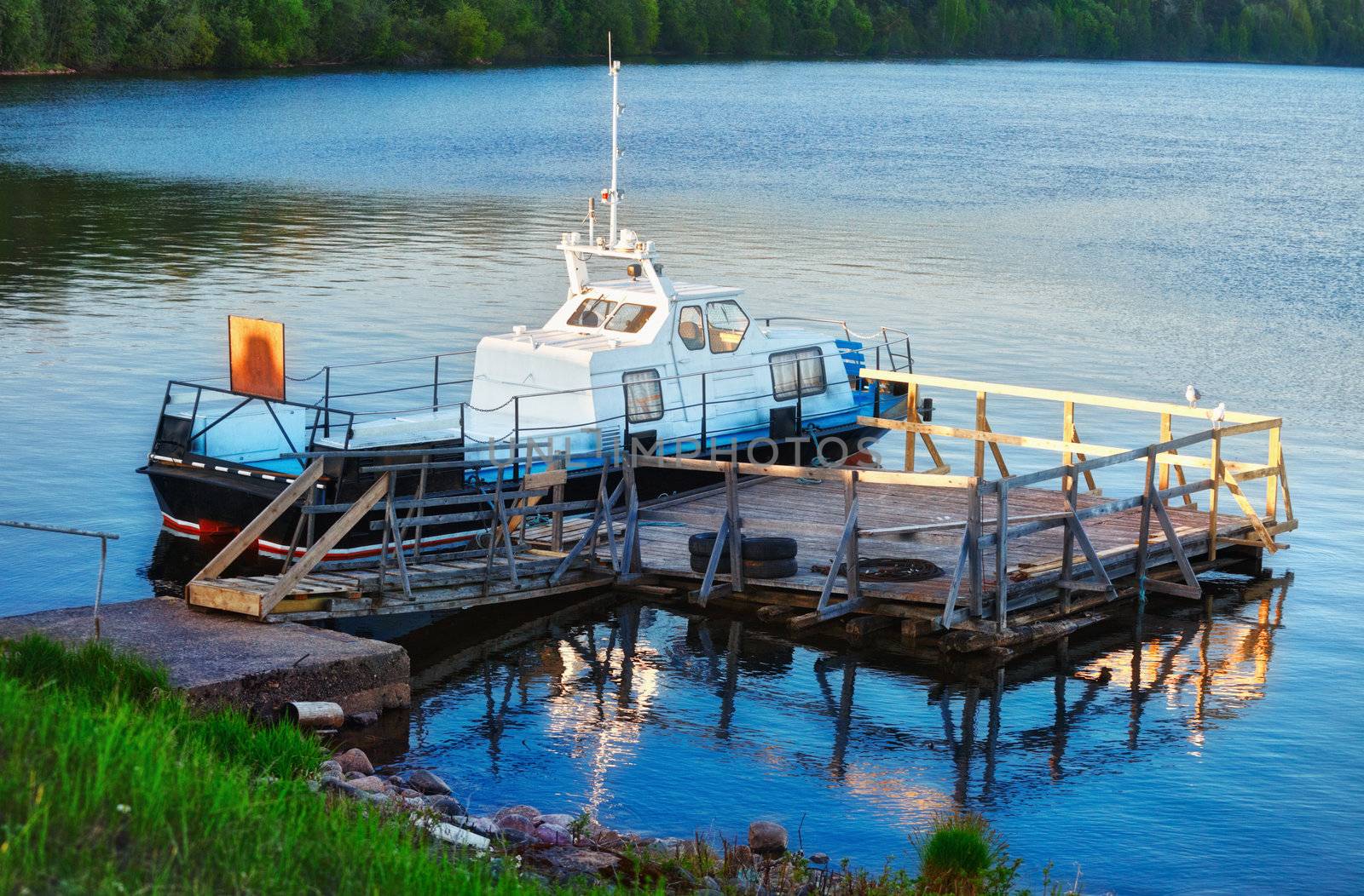 patrol boat docked on calm lake at evening