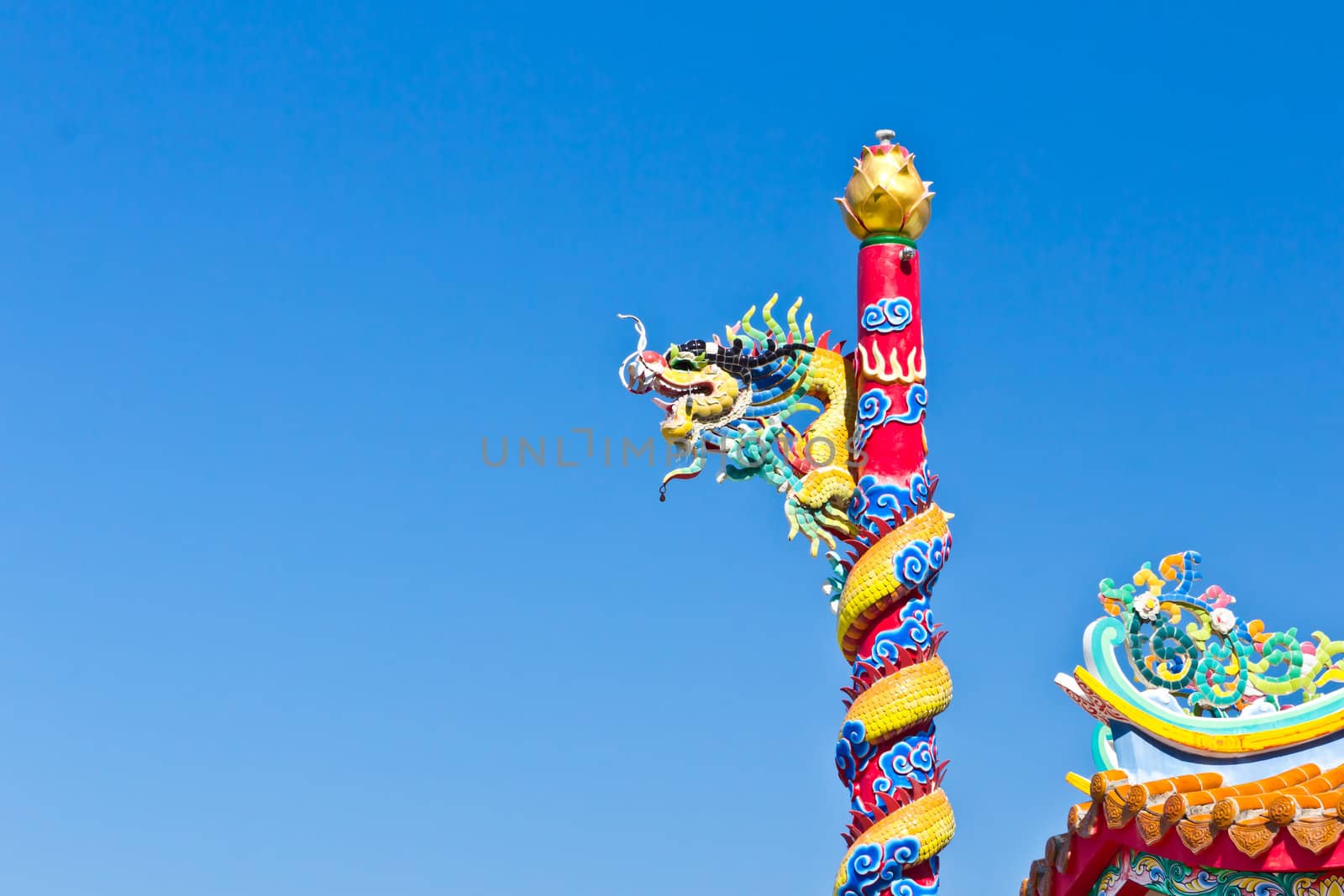 dragon statue against blue sky in chinese temple by tungphoto