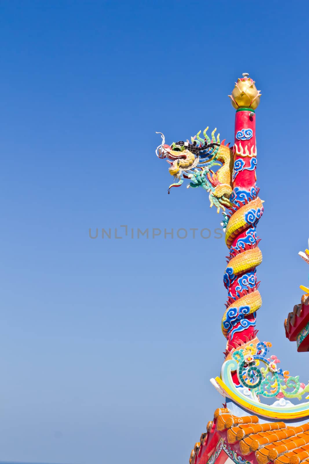 dragon statue against blue sky in chinese temple by tungphoto