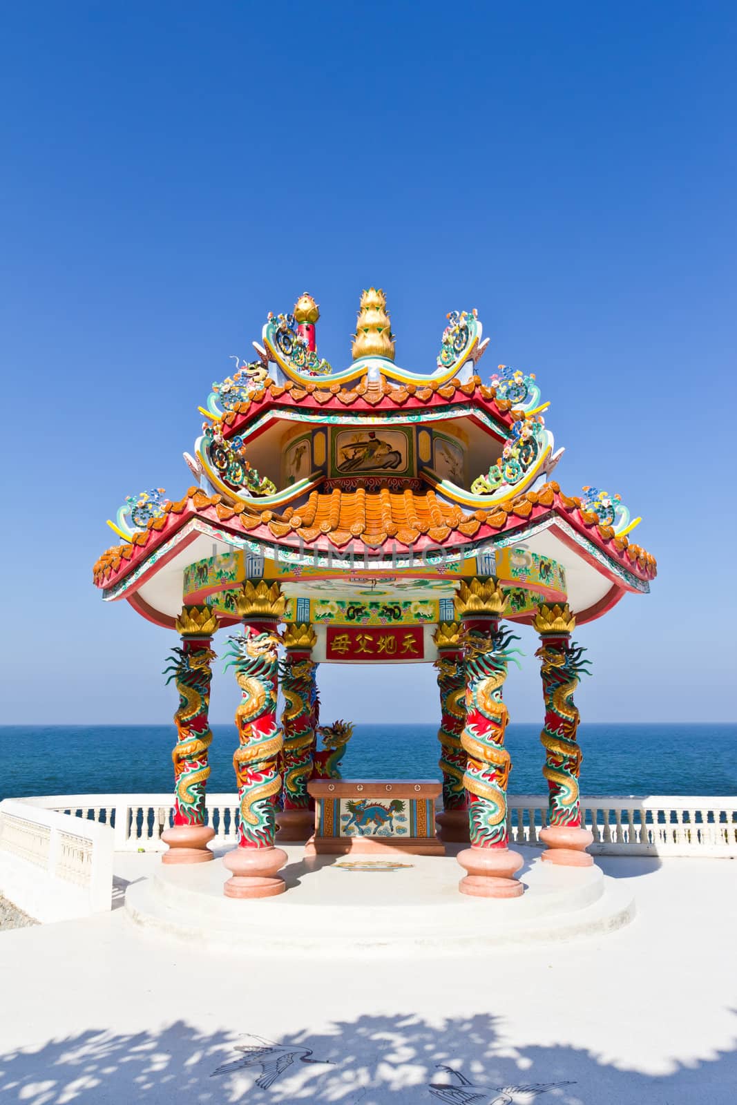 dragon pavilion against blue sky in chinese temple by tungphoto