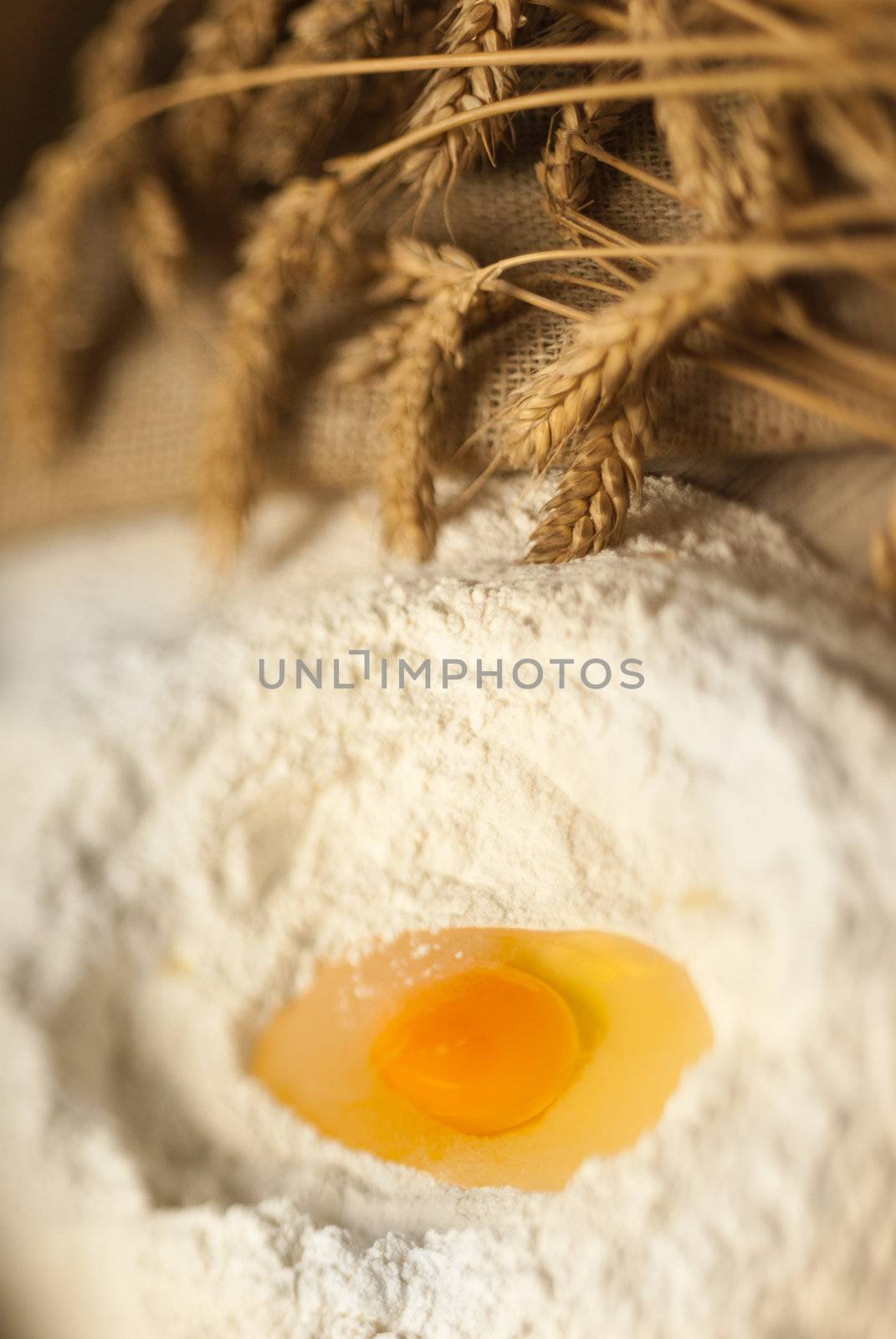 Defocused baking tray with wheat and eggs