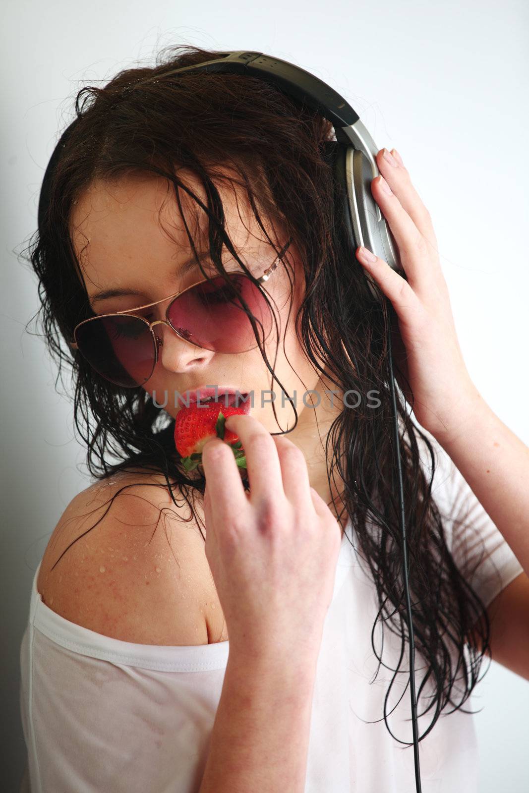 happy woman dance in phones and eat strawberry