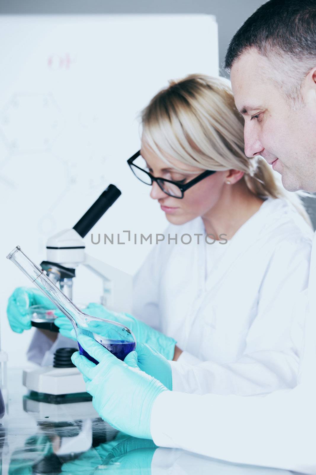  two scientist in chemical lab conducting experiments