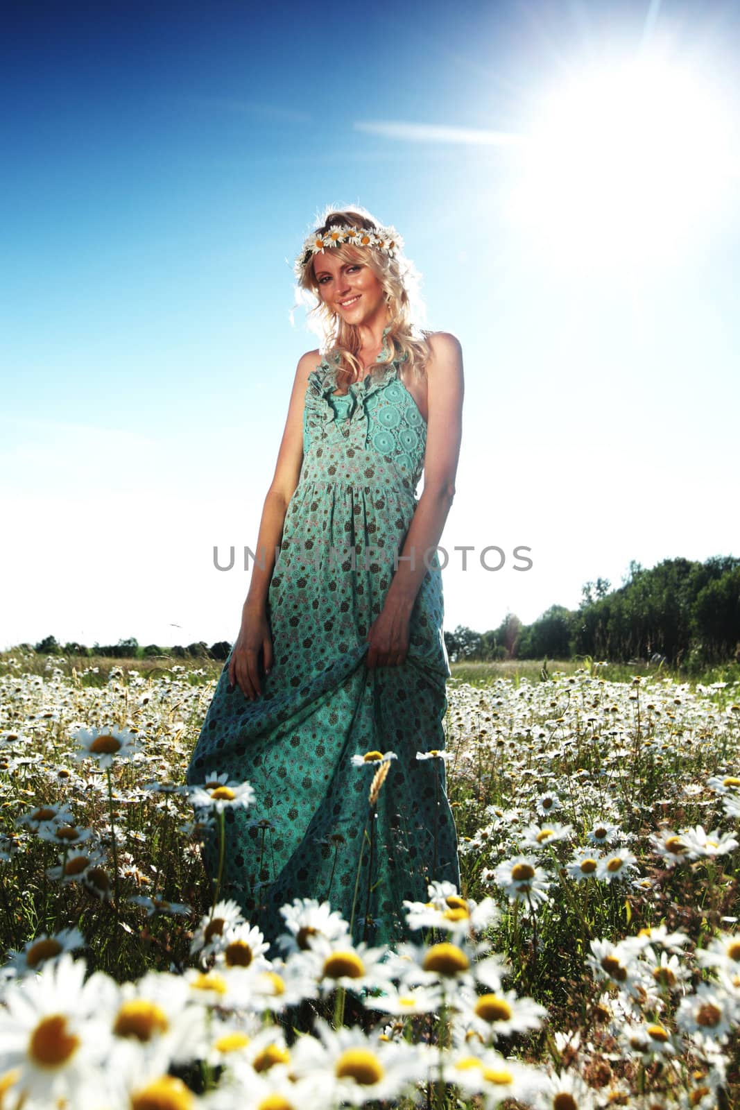  beautiful girl  in dress on the sunny daisy flowers field 