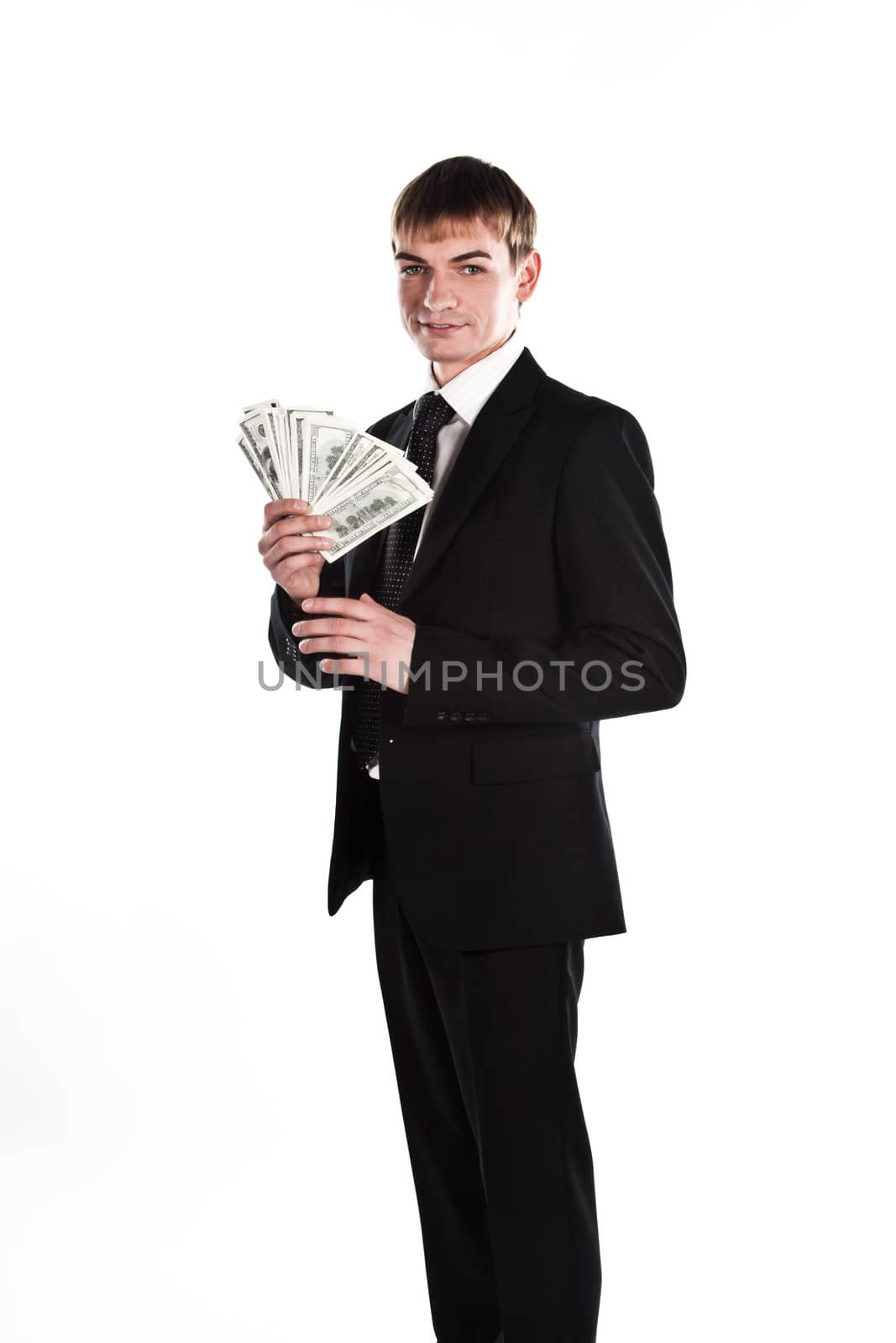 Portrait of a young businessman in a dark suit surrounded by flying dollar bills