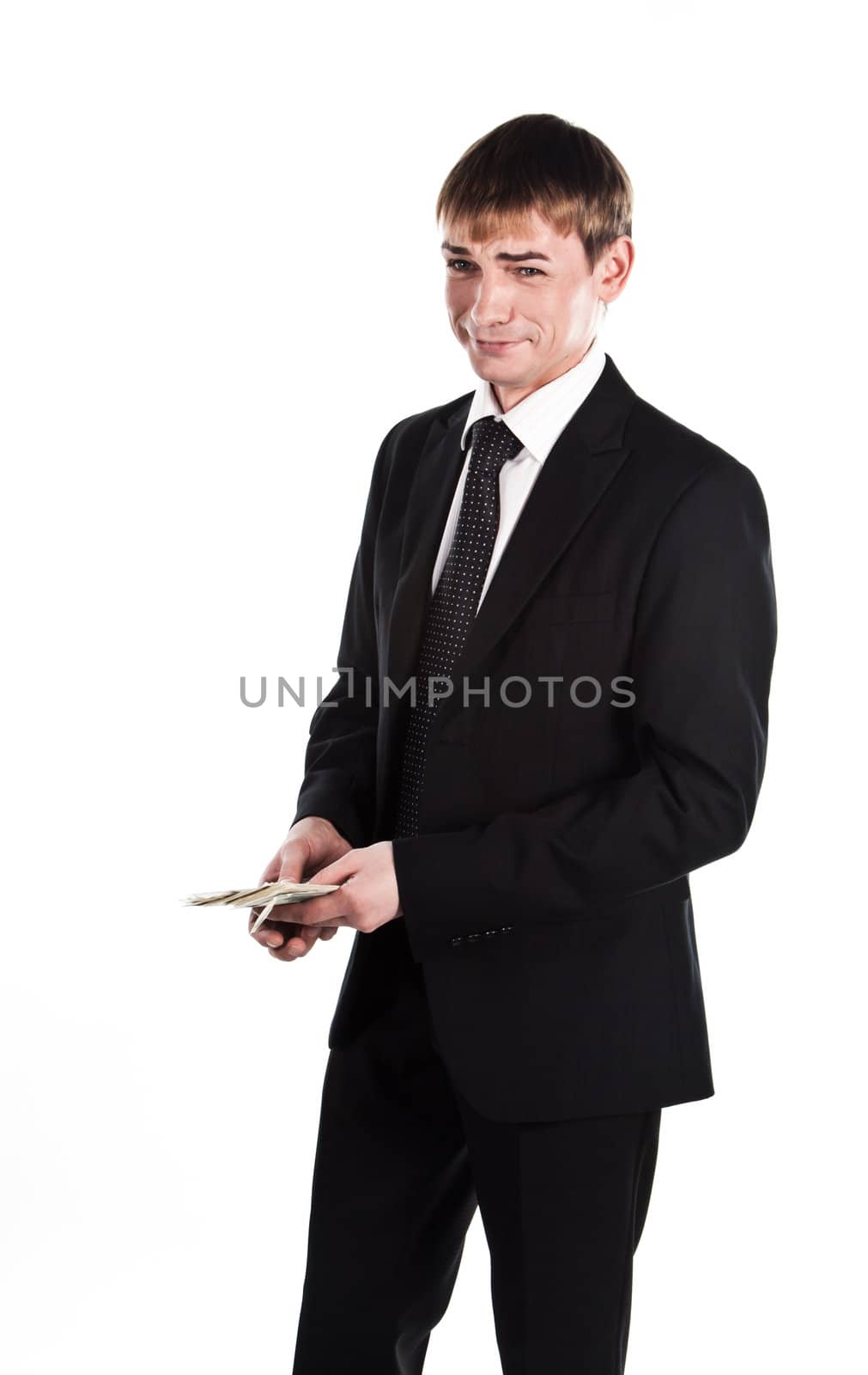 Portrait of a young businessman in a dark suit surrounded by flying dollar bills