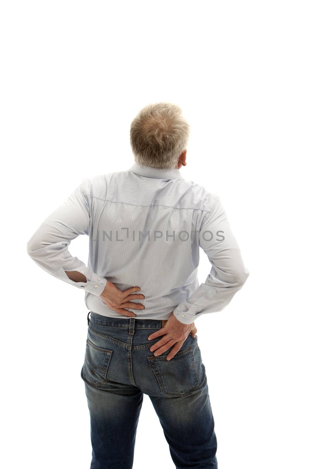 Middle-aged man has back pain. He keeps his back and can be seen from behind.